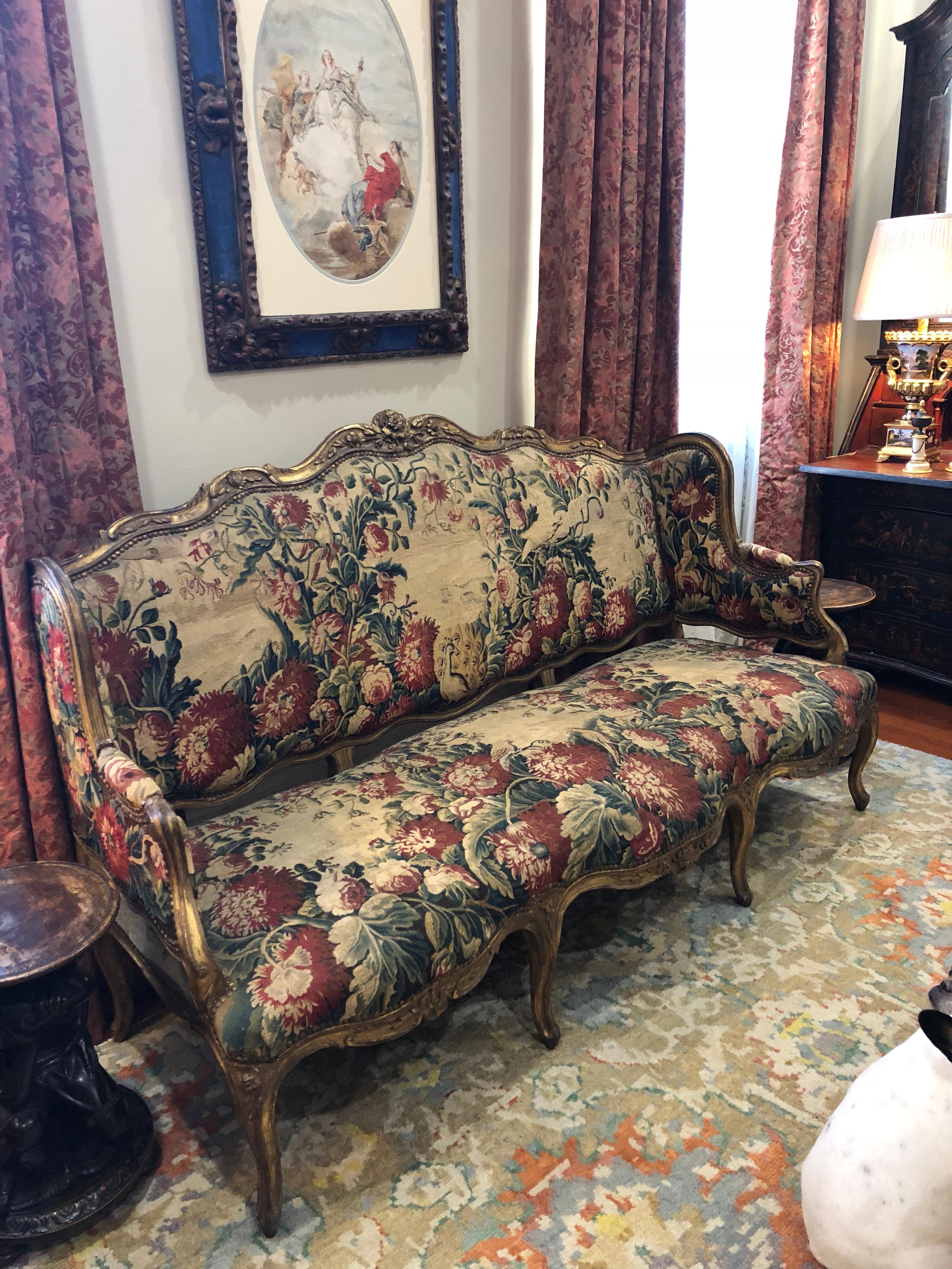 18th century French Aubusson covered sofa with giltwood frame. The frame is pegged appropriately and the Aubusson is in excellent shape. No major tears or rips. This was deaccessioned from a small museum in the mid west.
 