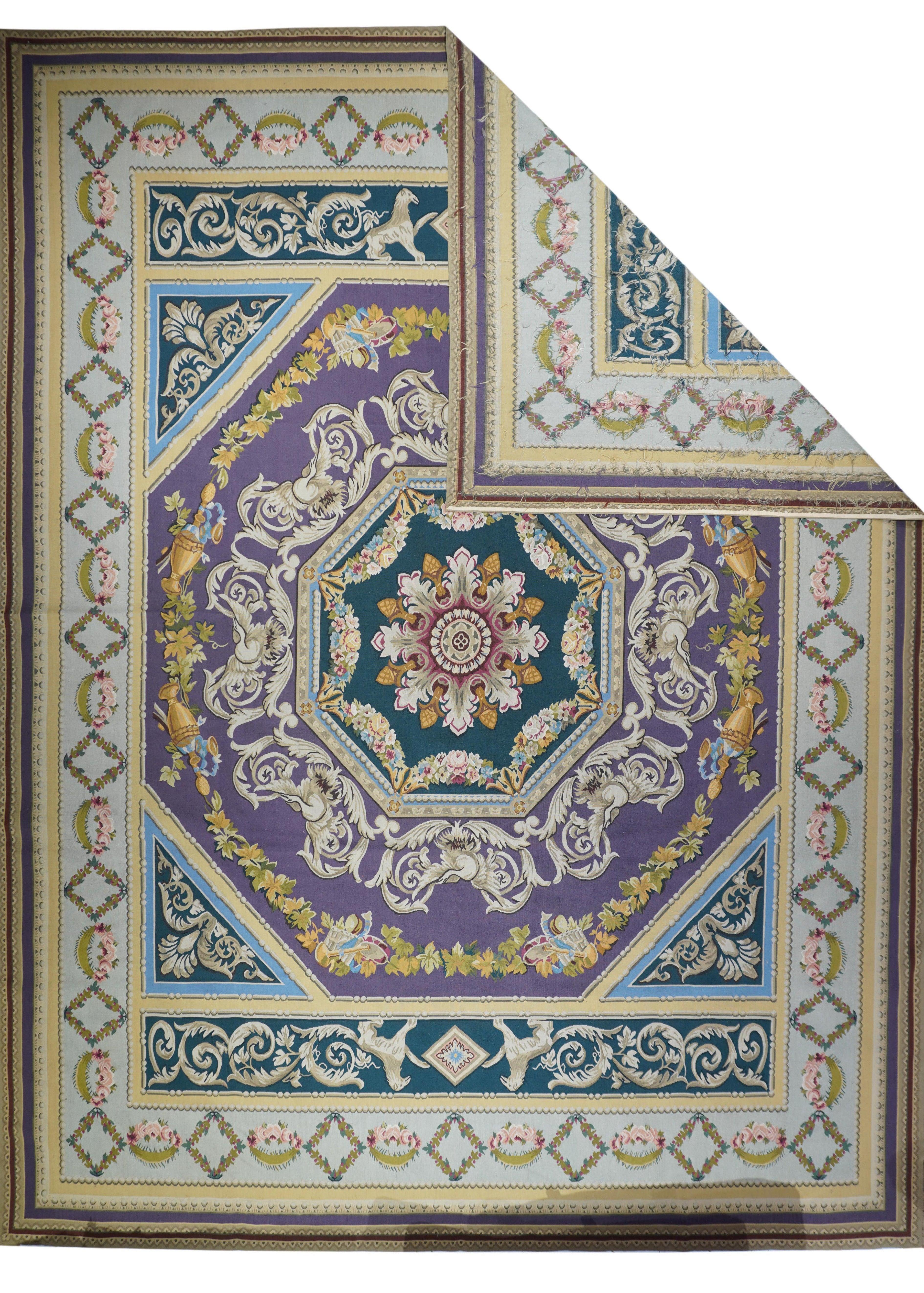 French Aubusson Design Rug 12'0'' x 15'0''. In a French Directoire Aubusson style, the central purple octagon is focused on an acanthus octofoil, and set and set within a swagged octagonal frame. Conforming outer acanthus frame and wreath with