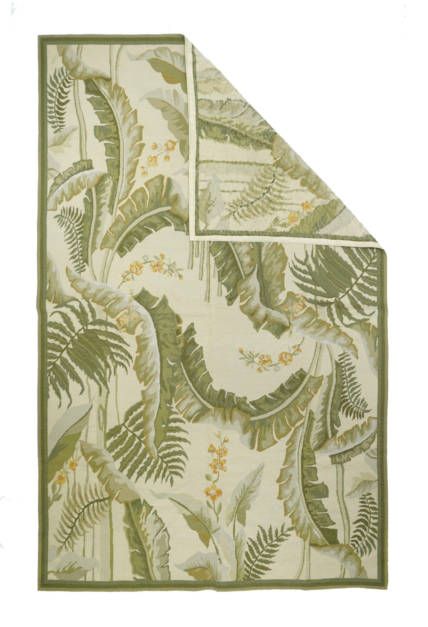 French Aubusson Design Rug 5'11'' x 8'11''. The near black field explodes with six large tropical flower and giant leaf roundels enclosing colorful birds; and two smaller end reserves enclosing tropical scenery vignettes. Palm trees float in the