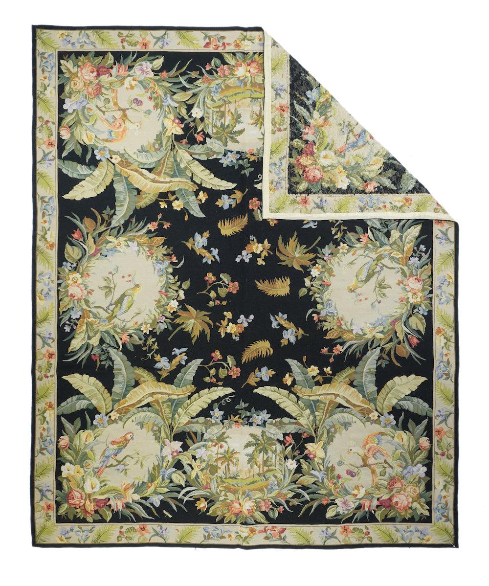 French Aubusson Design Rug 8'0'' x 10'0''. From our tropical scenery series, this near black field piece is a larger version of 18419, with exuberant leafy pictorial roundels featuring colorful exotic birds or palm Ð shade beach scenes. Palm trees,