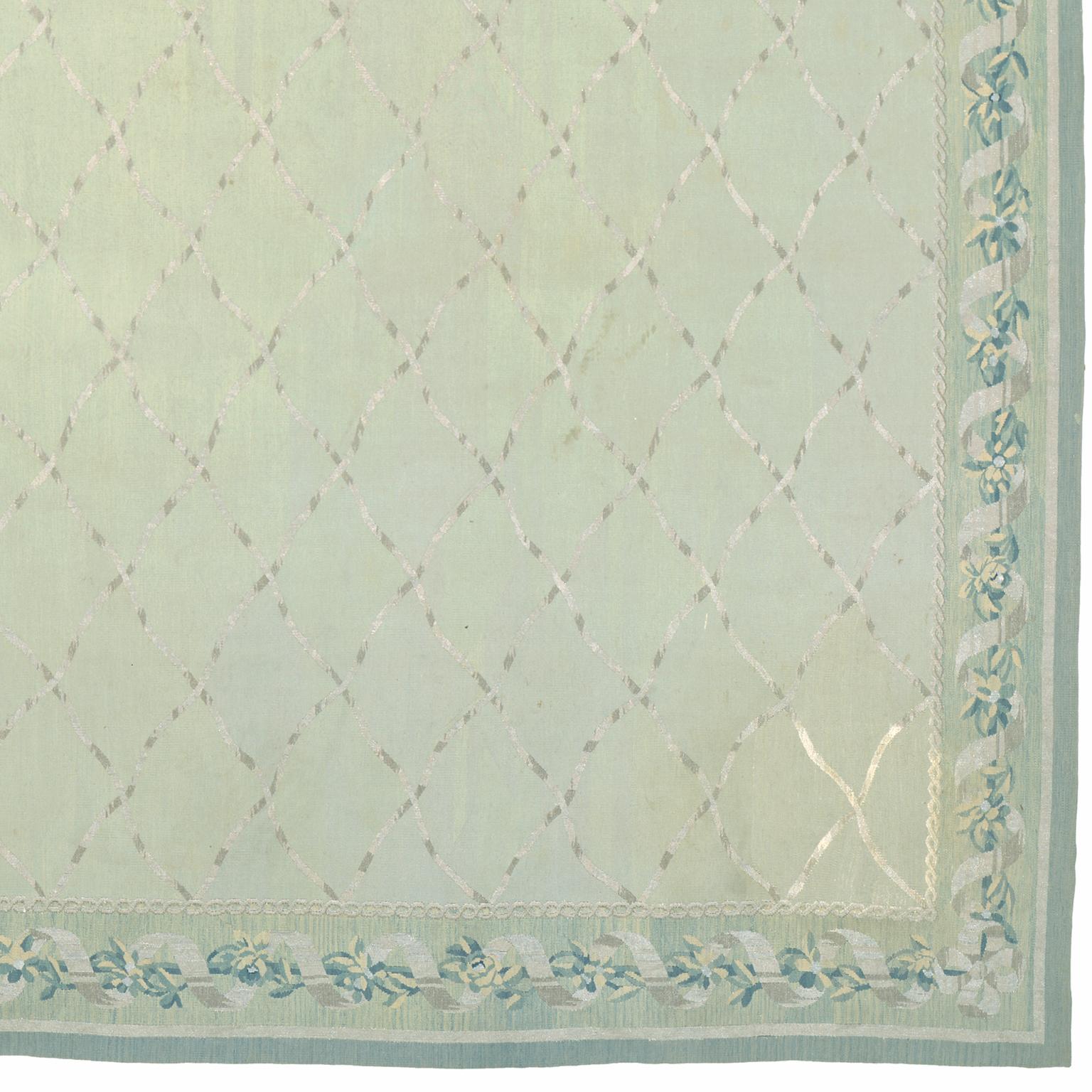 French Aubusson rug by Stéphane Boudin of Jansen
France circa 1950
A light celadon field with a silver metallic thread ribbon trellis overall within a light blue metallic ribbon and rosette vinery border.
Designed by Stéphane Boudin of Jansen.