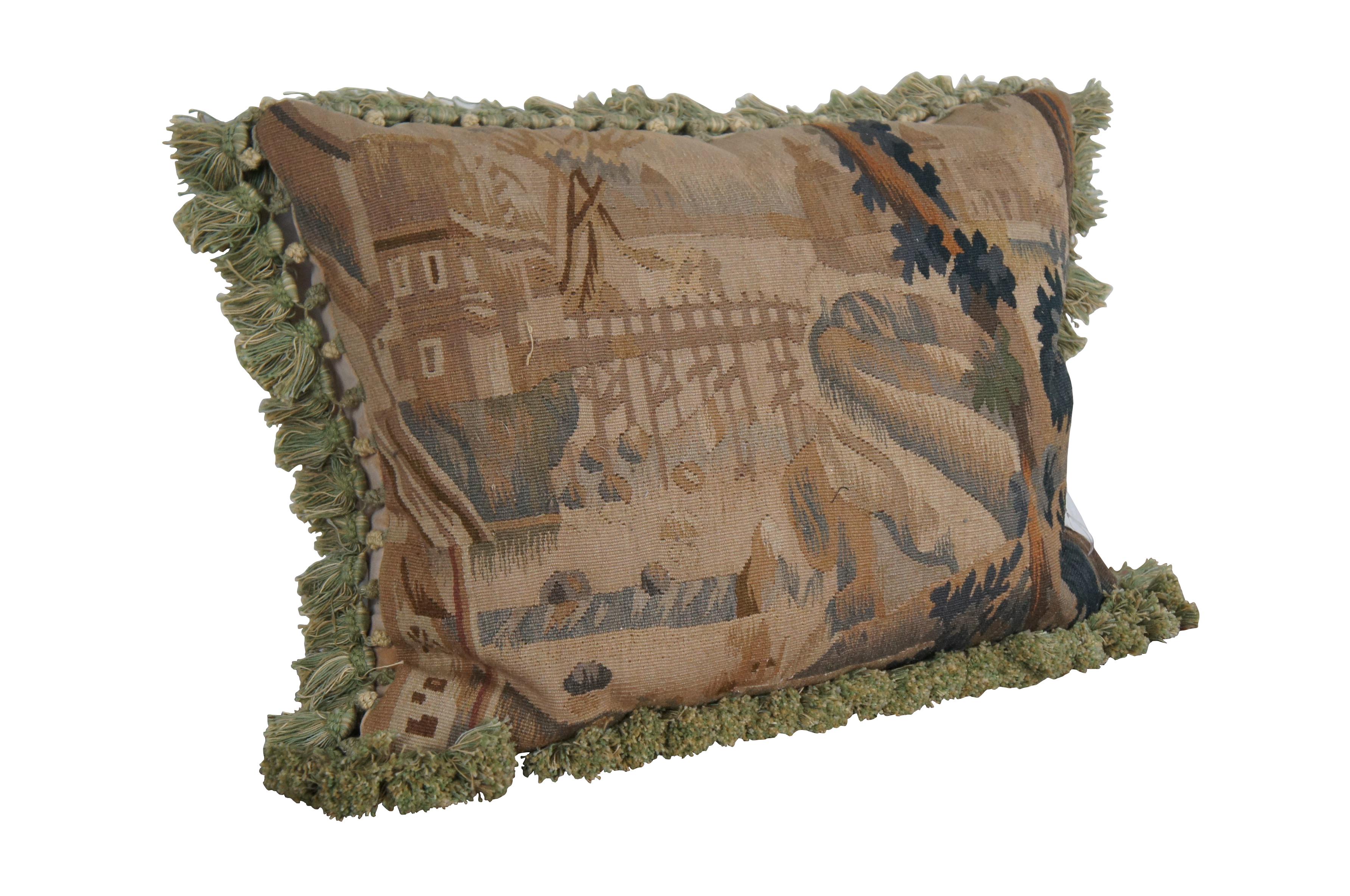 3 Available - 20th century French Aubusson style square throw pillow, embroidered in wool showing a cityscape along a river, framed with rocks and trees. Cream and green tassel trim. Light brown velour back with zipper closure. Down