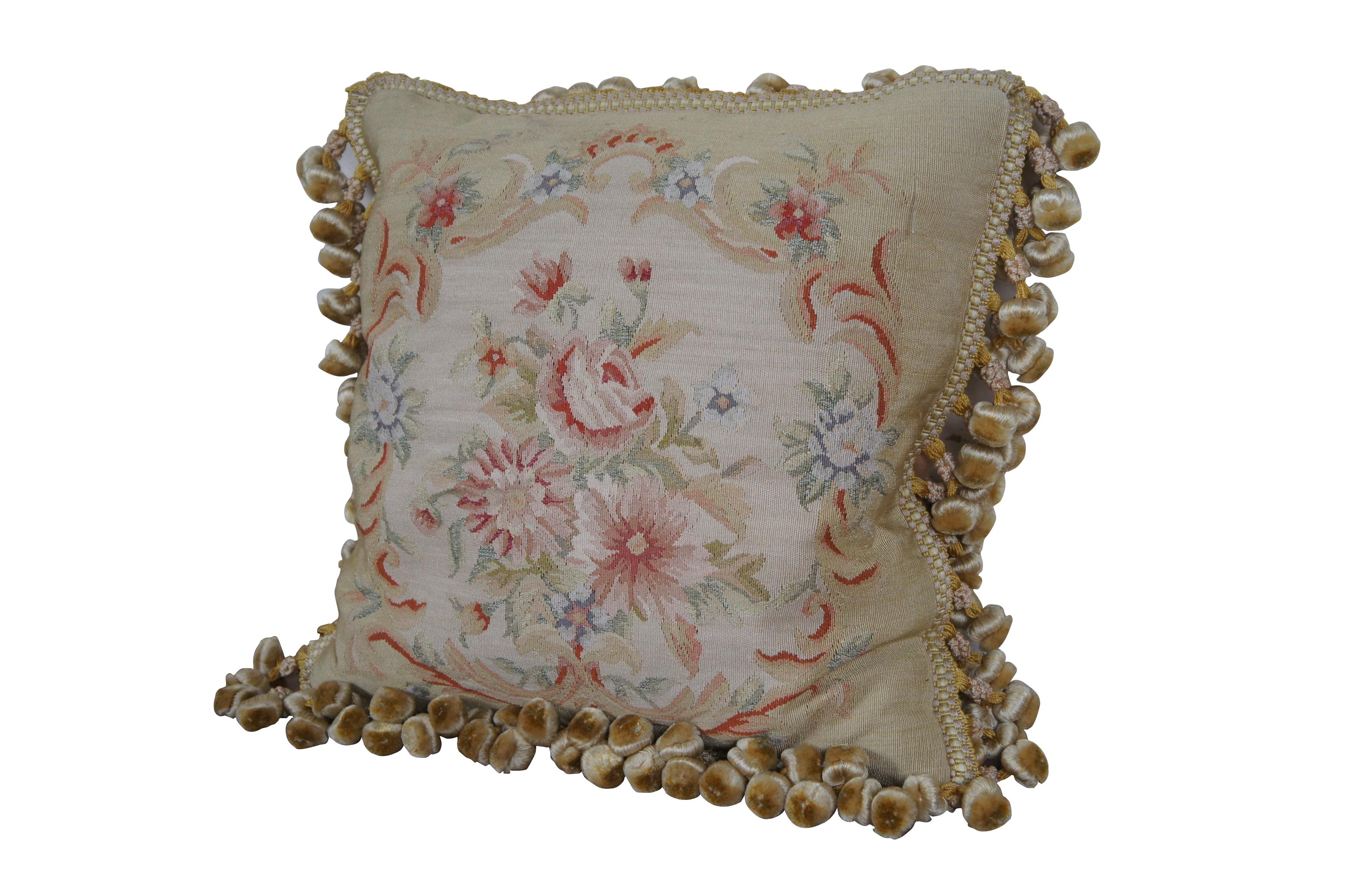 20th century square throw pillow, embroidered in silk with a bouquet of pink and blue flowers, surrounded by a swirling, peach, foliate frame. Gold and cream ball tassel trim. Beige velour back with zipper closure.  Down filled.

Dimensions:
16