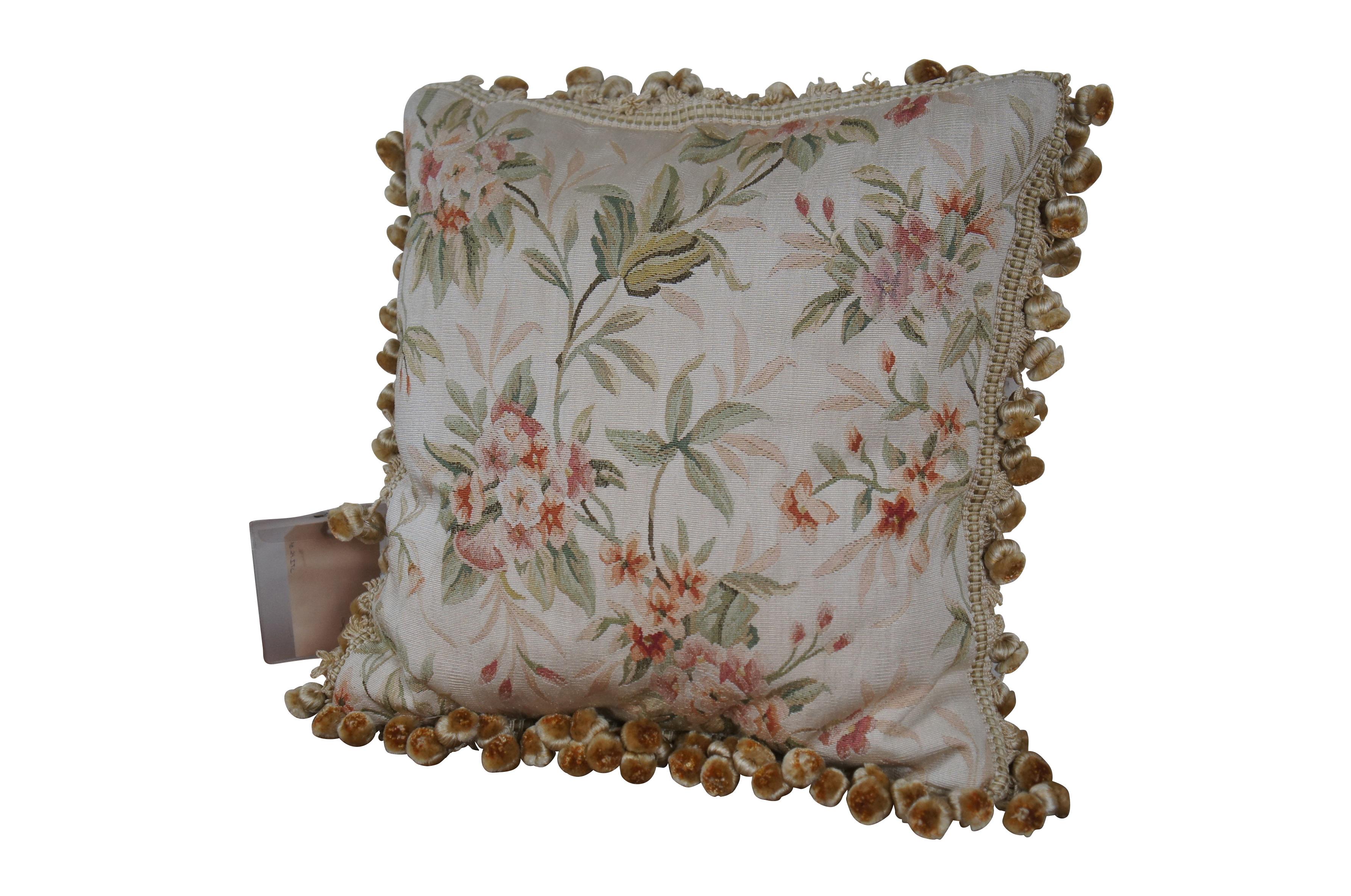 20th century Aubusson style square throw pillow, embroidered in silk with bunches of pink and rust colored flowers amid stems of green and pale pink leaves. Cream ball tassel trim.  Light brown velour back with zipper closure. Down