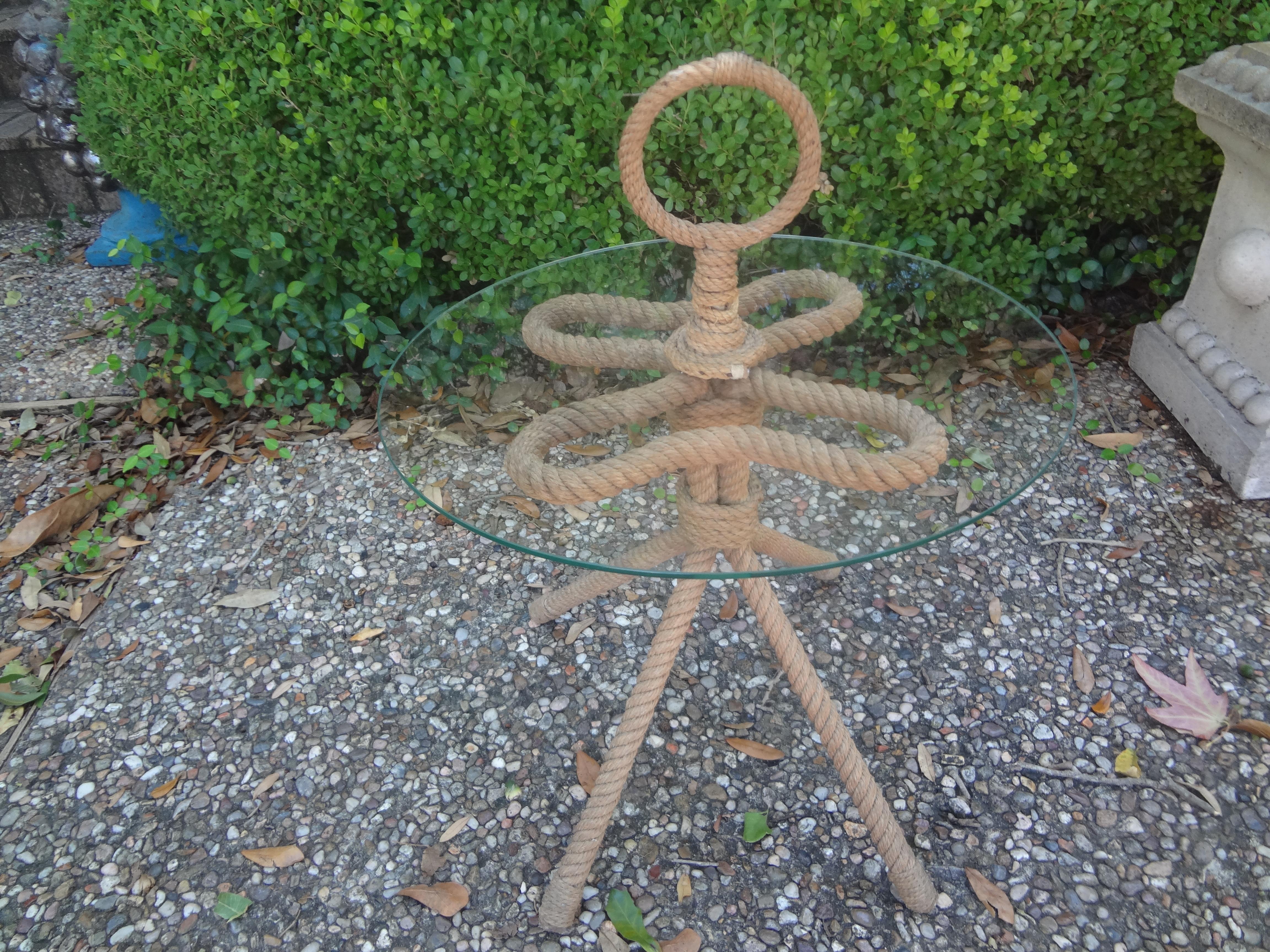 French Audoux & Minet Rope And Glass Table.
This handsome French rope table or gueridon by Adrien Audoux And Frida Minet was realized in the 1950's with the most unusual design featuring three legs with a glass top and rope handle. Our rare Audoux &