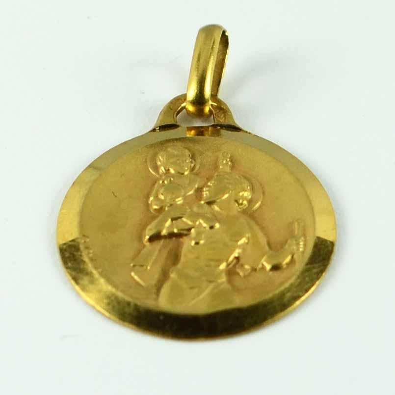 A French 18 karat (18K) yellow gold charm pendant or medal designed by Augis depicting St Christopher carrying the infant Christ across the river. This unusual version is modelled in high relief for a strongly three-dimensional feel, has incredible