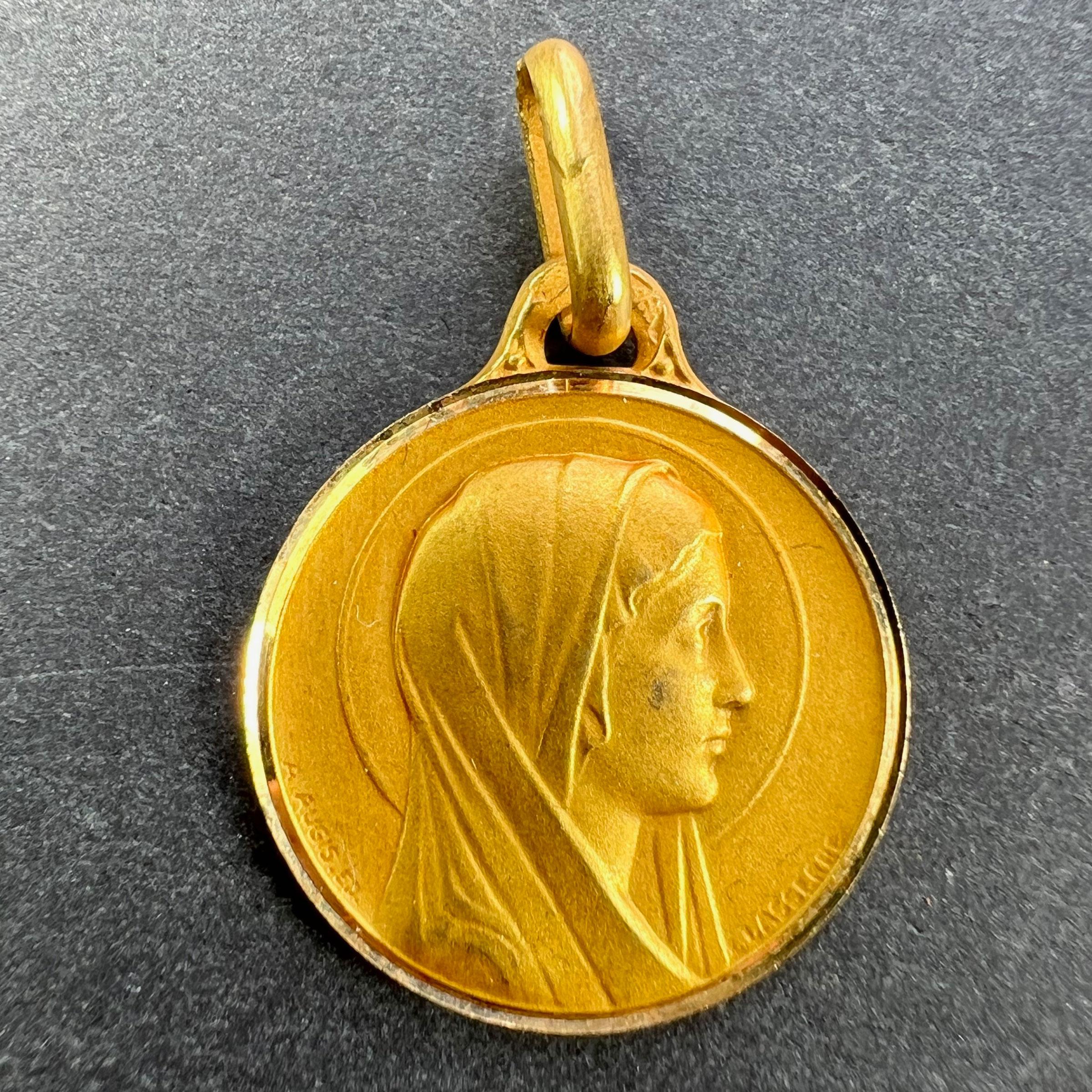 A French 18 karat (18K) yellow gold pendant designed as a round medal depicting the Virgin Mary in profile with a halo. Signed Lasserre and A.Augis. Stamped with the eagle’s head for French manufacture and 18 karat gold, with maker’s mark for