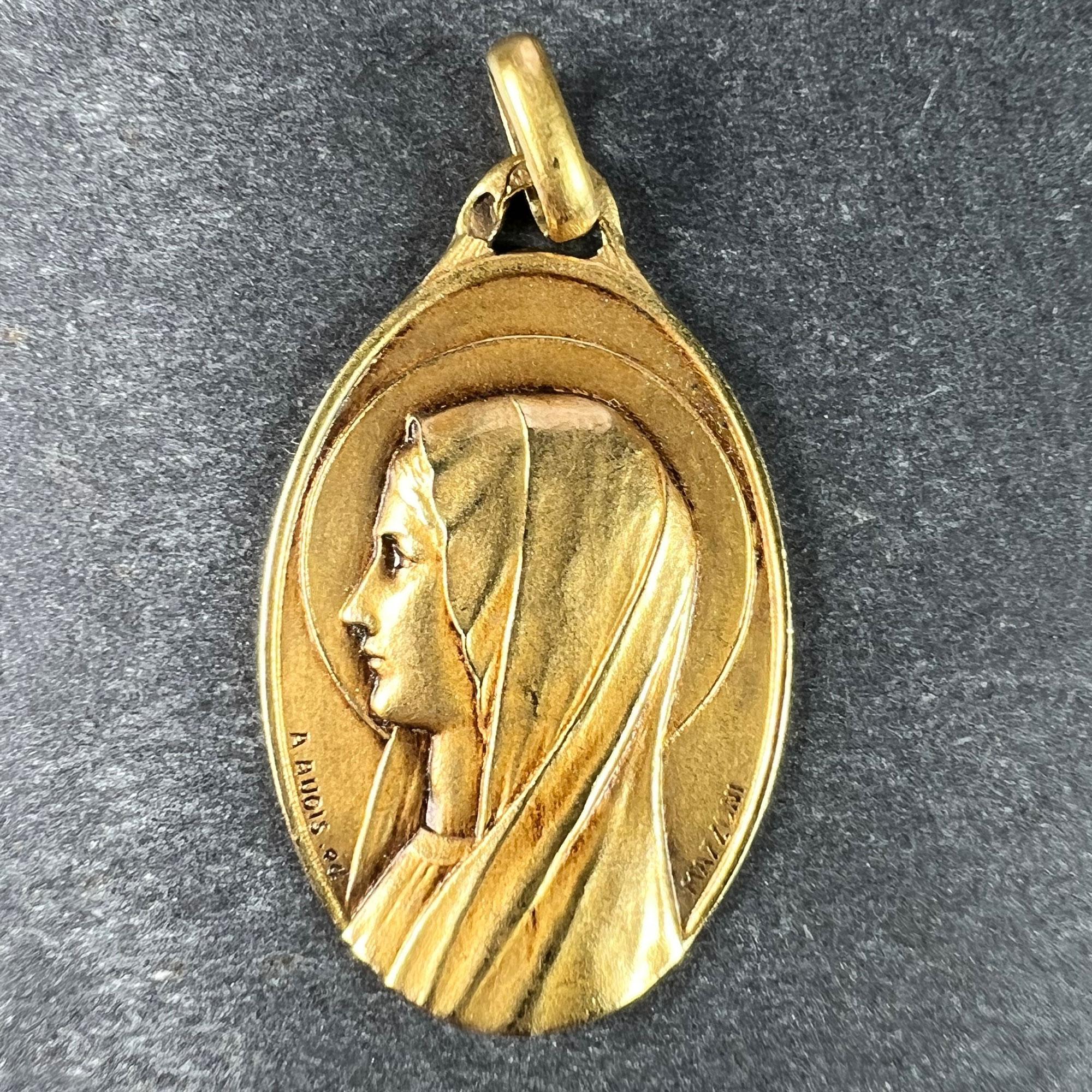 A French 18 karat (18K) yellow gold charm pendant depicting the Virgin Mary, signed A.Augis ED (made by) and Mazzoni SC (sculptor). Engraved to the reverse with the monogram SJ/JS and the date 10 Mai 1934. Stamped with the eagles head for French