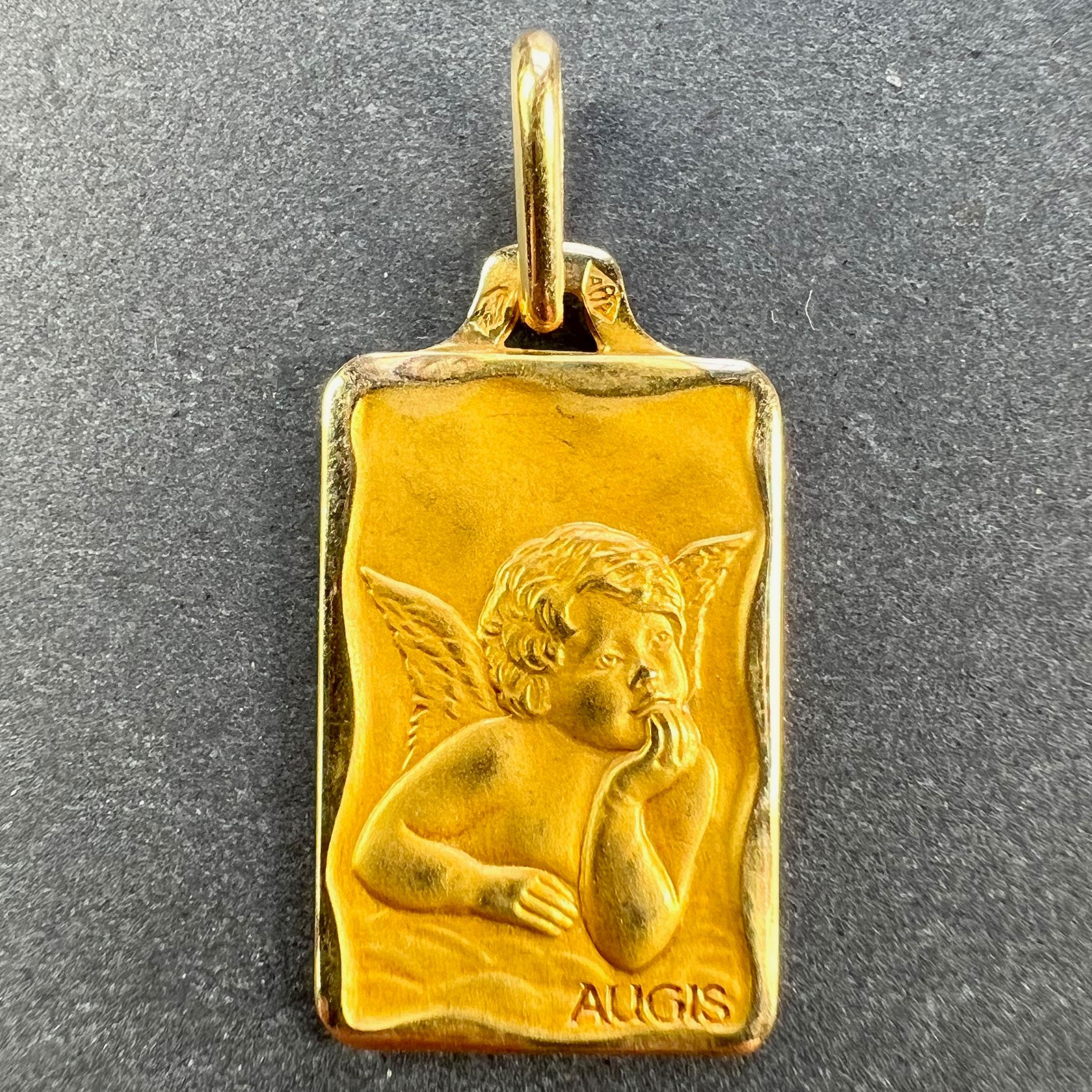 A French 18 karat (18K) yellow gold charm pendant designed as a rectangular medal depicting Raphael’s cherub. Signed Augis. Stamped with the eagle mark for 18 karat gold and French manufacture with an unknown maker's mark.

Dimensions: 2 x 1.1 x 0.1