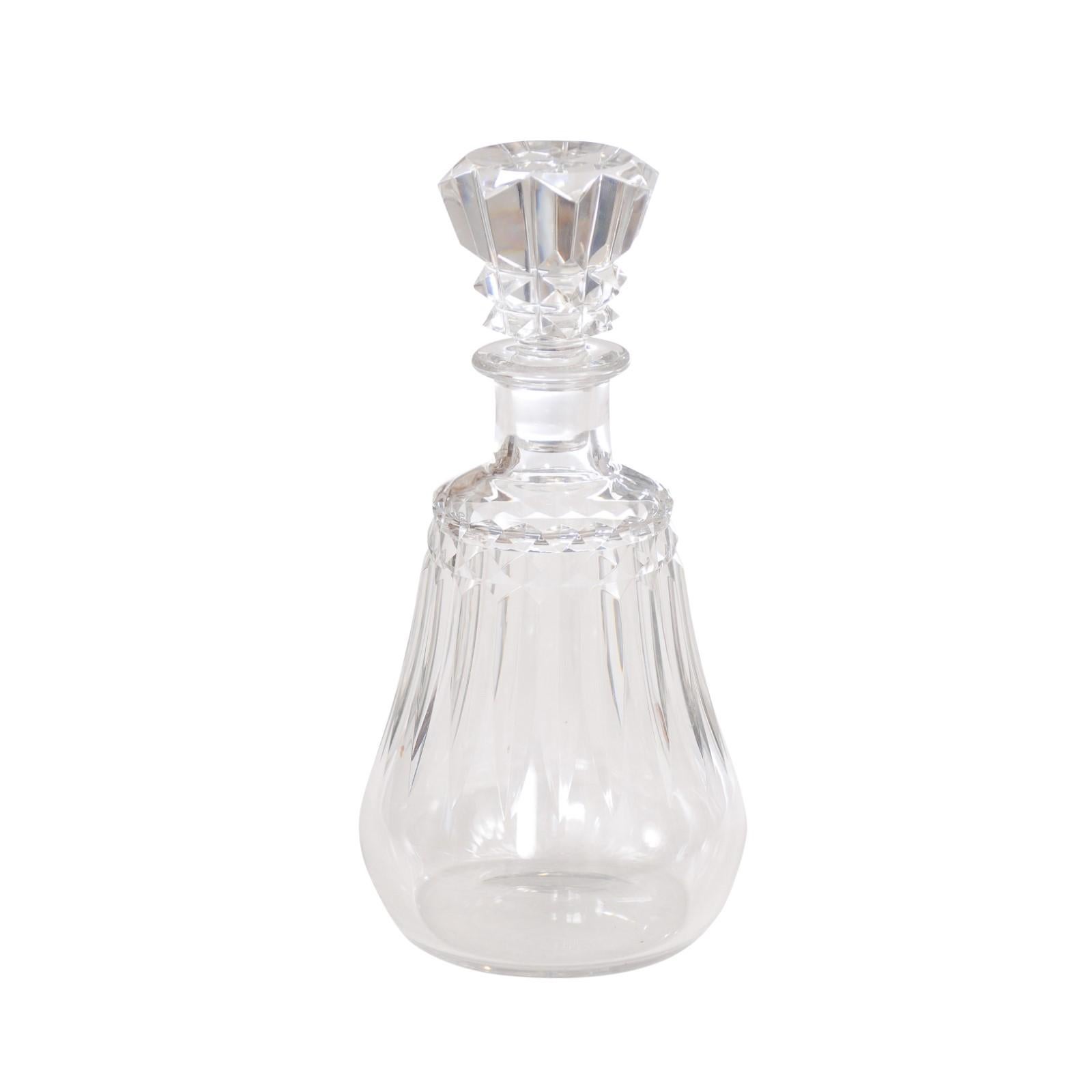 A French Baccarat crystal decanter circa 1940 with cutaway motifs and pear shaped body. Elevate your dining experience with this French Baccarat crystal decanter from the circa 1940s. Meticulously crafted, this decanter showcases the timeless beauty