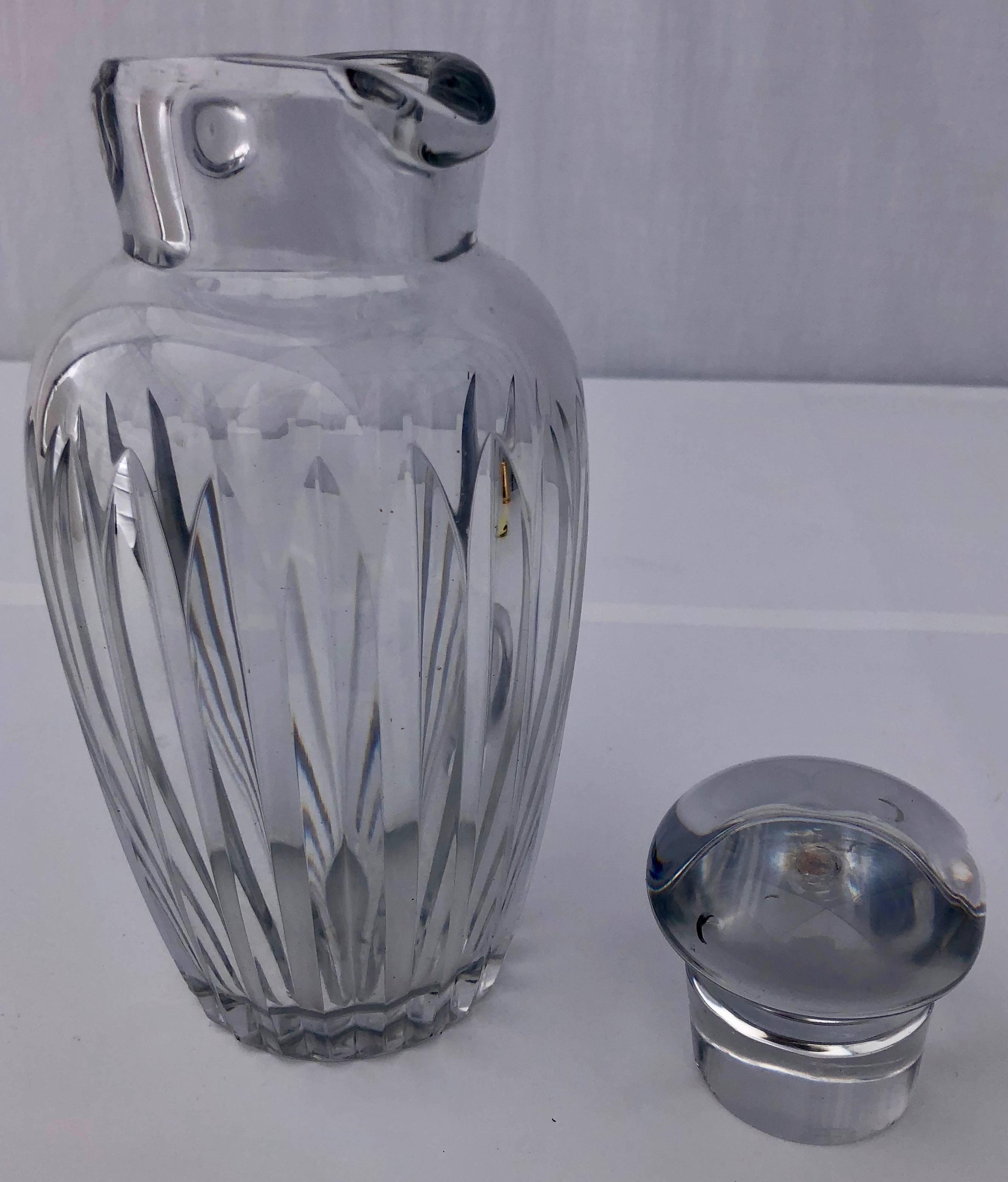 This lovely French Baccarat crystal whisky carafe (decanter) has two spouts and a dome shaped lid and the Baccarat seal underneath the carafe in the center.
 