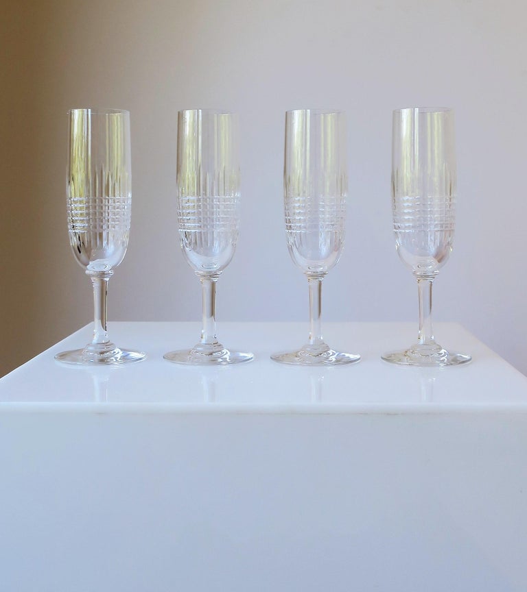 There are two sets of four (4) available for purchase. 

A beautiful sleek set of four (4) French cut crystal Champagne flutes/glasses from luxury house Baccarat, circa late-20th century, France. In the 'Nancy' pattern. All marked on bottom with