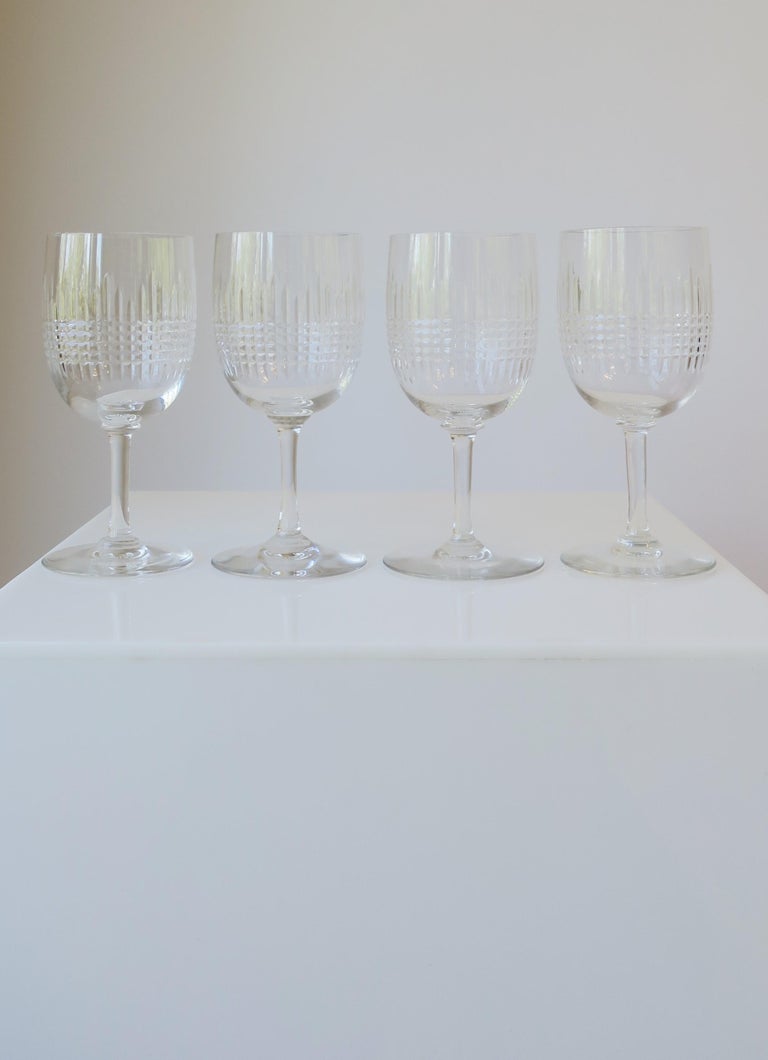 There are two sets of four (4) available for purchase. 

A beautiful set of four (4) cut crystal wine, water or cocktail glasses from French luxury house Baccarat, circa late-20th century, France. In the 'Nancy' pattern. All marked on bottom with