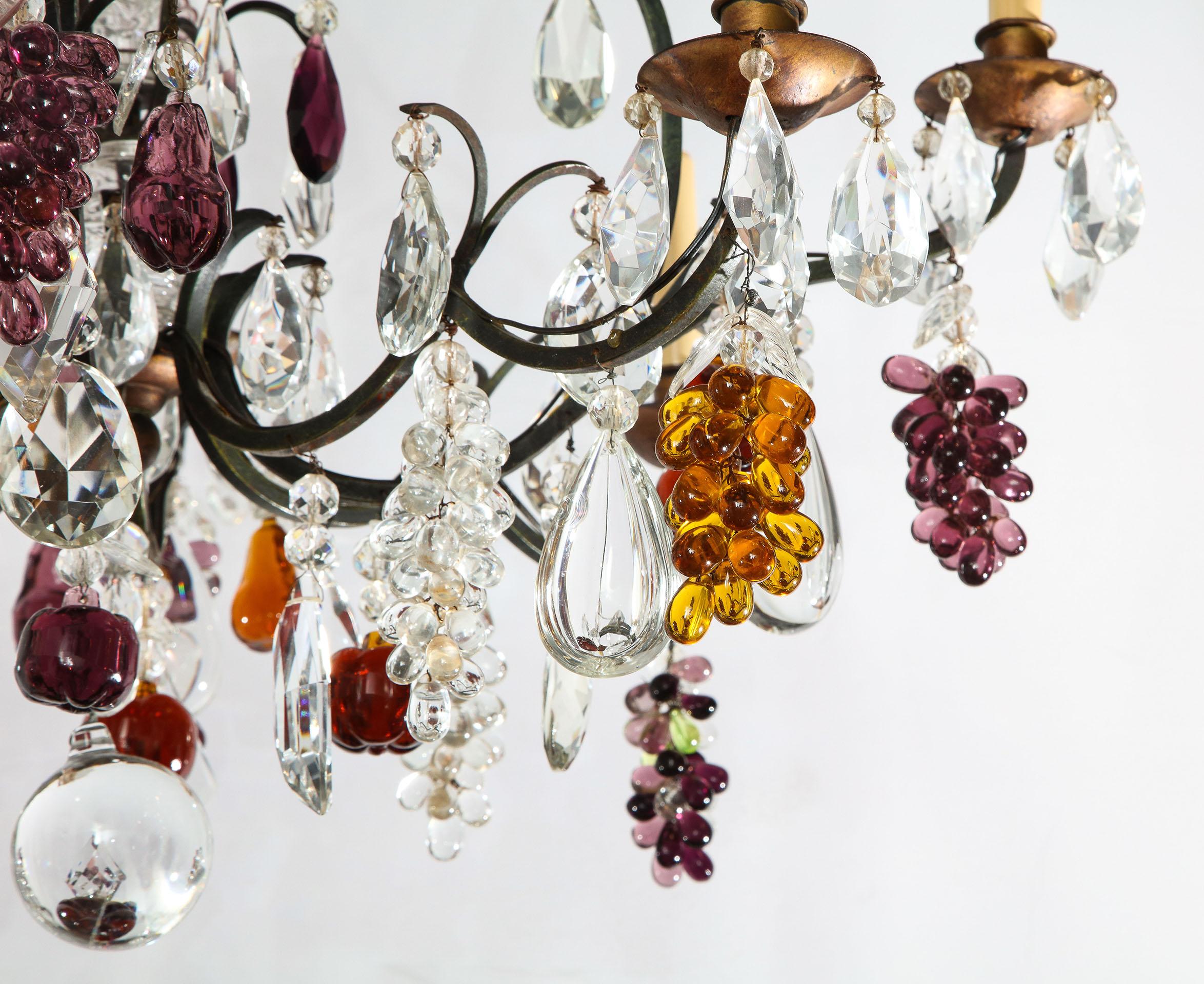 French eight-light chandelier with colored fruit pendants (Possibly Baccarat)

The eight-light chandelier having a canopy with several metal arms supporting clear drops, amber pears, amethyst apples and grapes, along with clear grapes and leaves