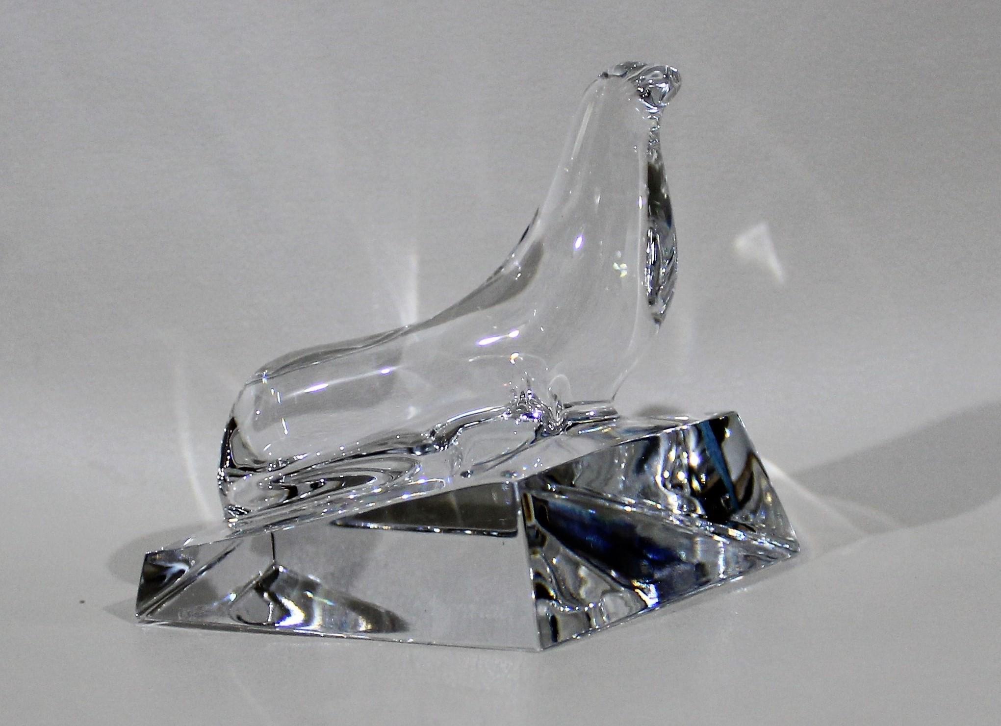 French Baccarat crystal sea lion sculpture posed on a sculpture of ice flow. The seal is softly sculpted, capturing expression and movement at every angle. The solid crystal glass is brilliant and clear and it is signed with the Baccarat signature