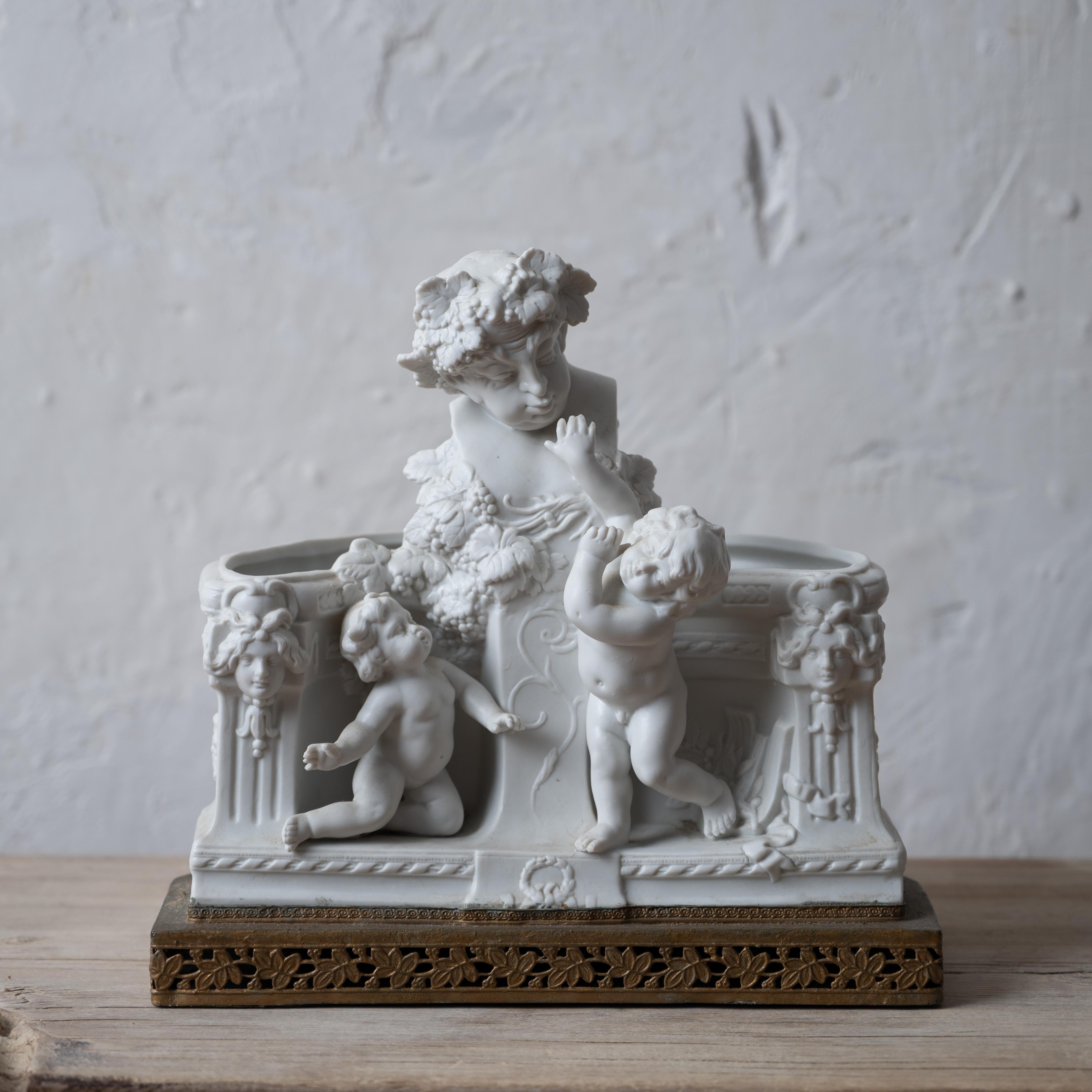 A bisque jardiniere depicting Bacchic scene with putto, France, 19th century.



9 ½ inches wide by 5 ½ inches deep by 9 inches tall




