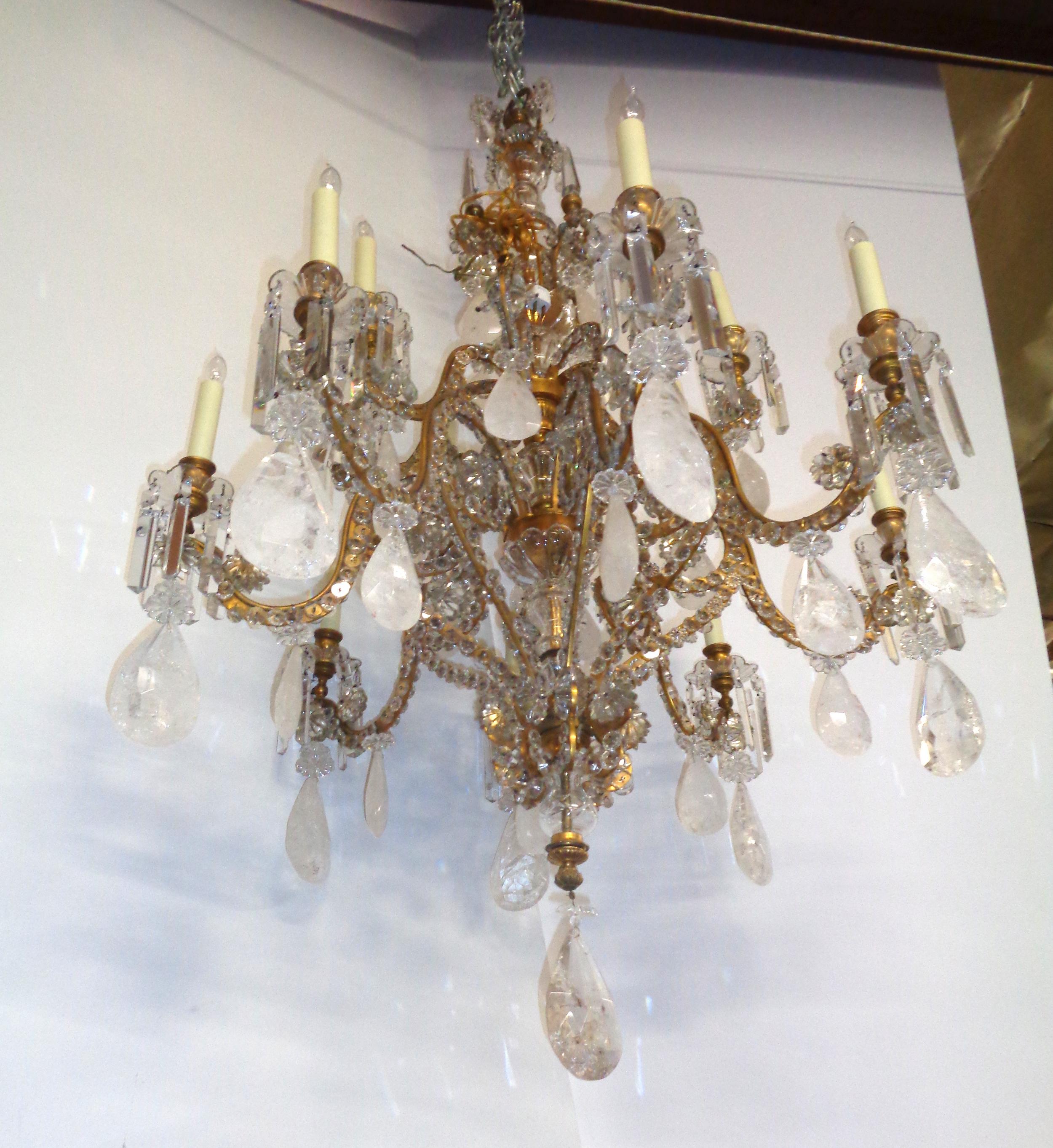 Magnificent original French Bagues rock crystal, bronze framed chandelier. The frame has beautiful crystal rosettes on all of the arms and bobeche cups under the sixteen graduated candlelights. The chandelier is newly electrified.