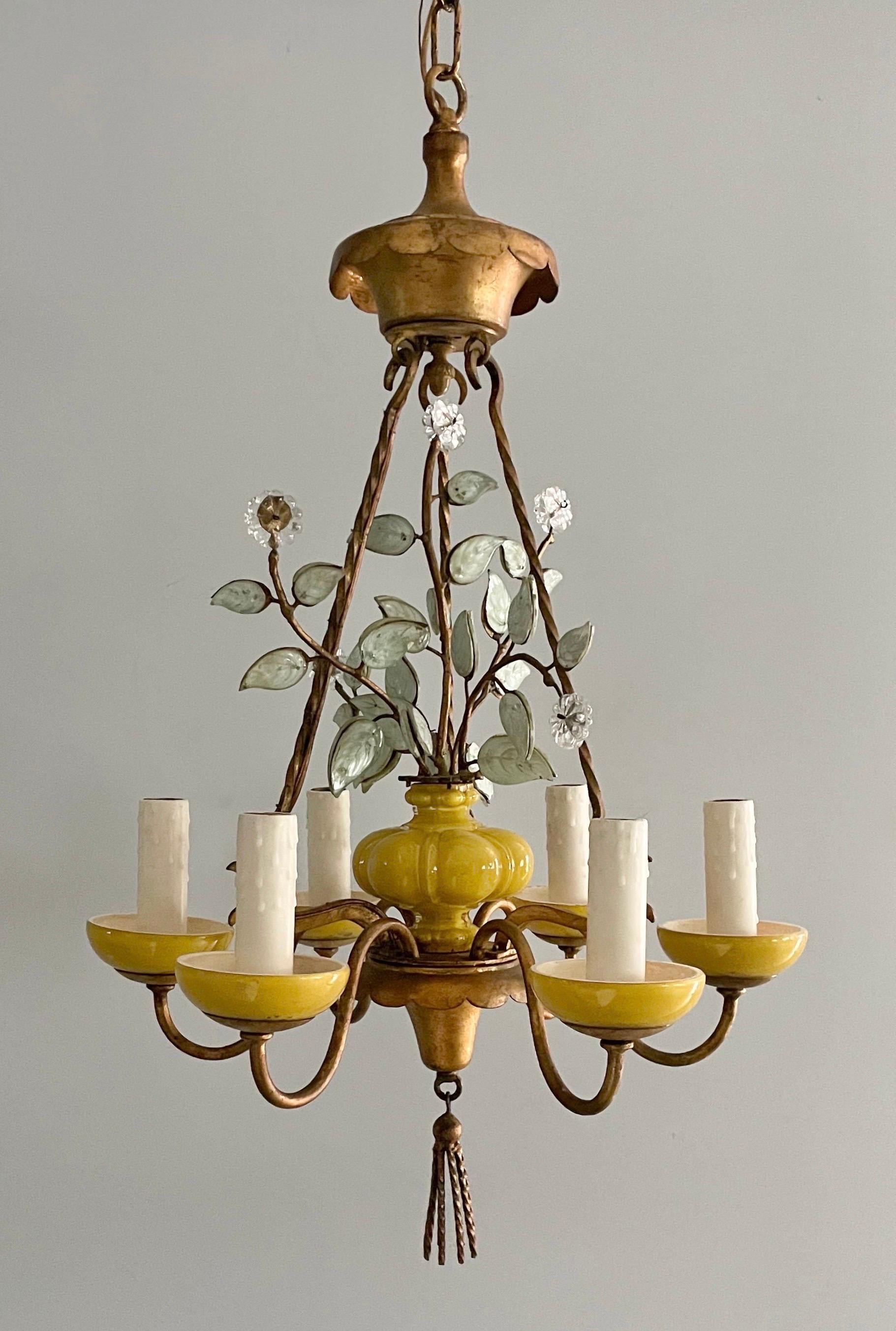 Chic, French Bagués-style chandelier by Paul Ferrante, Los Angeles, 2002.

The chandelier consists of gilded, detailed iron frame with reverse-painted glass components resembling an urn with leaves and flowers. 

The chandelier is wired and in