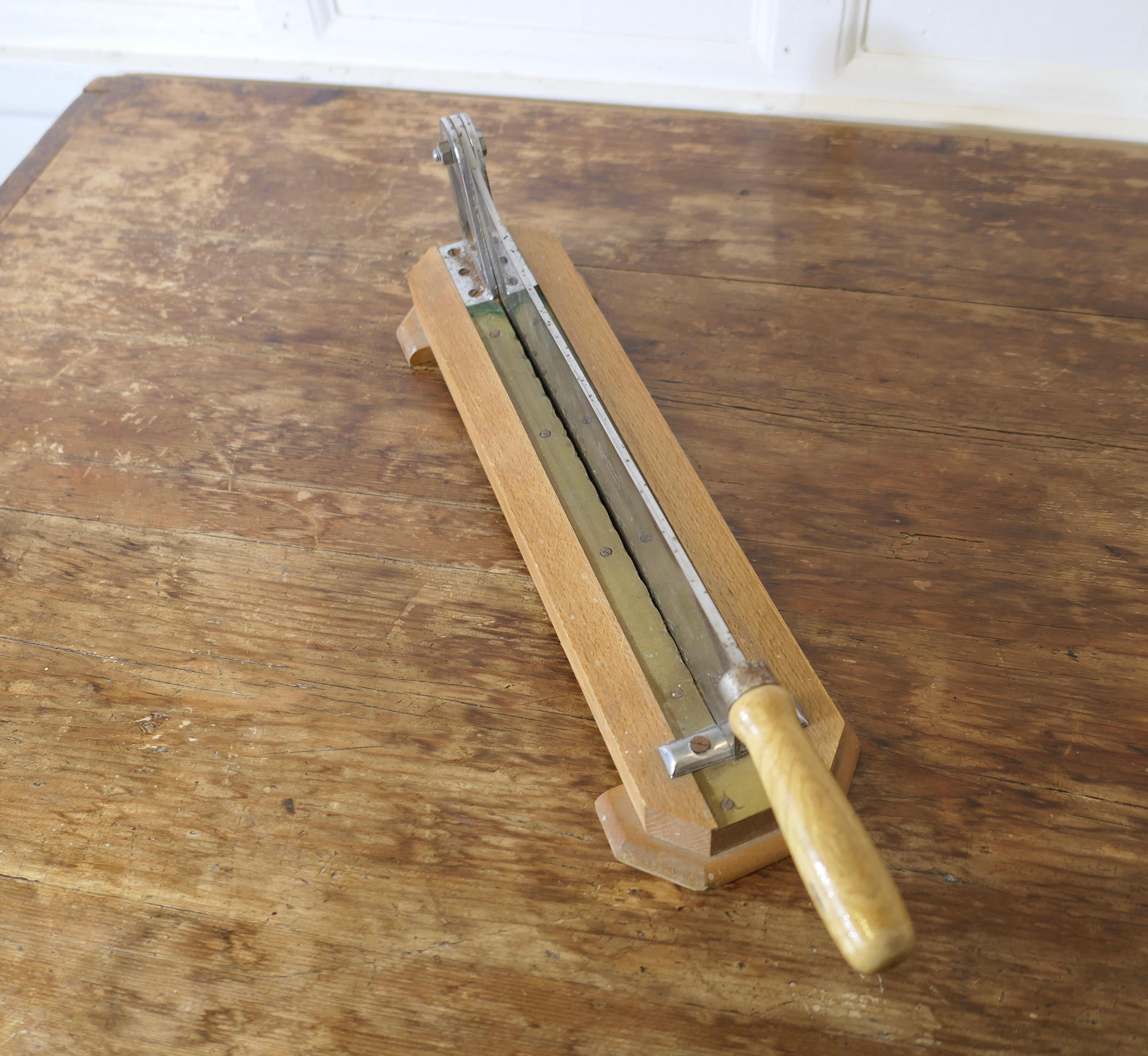 French Baguette Bread Cutter, Slicer, Guillotine 


A French bread and baguette guillotine, or slicer, on a wooden base with a heavy steel hinged serrated chopping knife
A great looking piece for a Restaurant, Bistro or Bakery
The Guillotine Knife