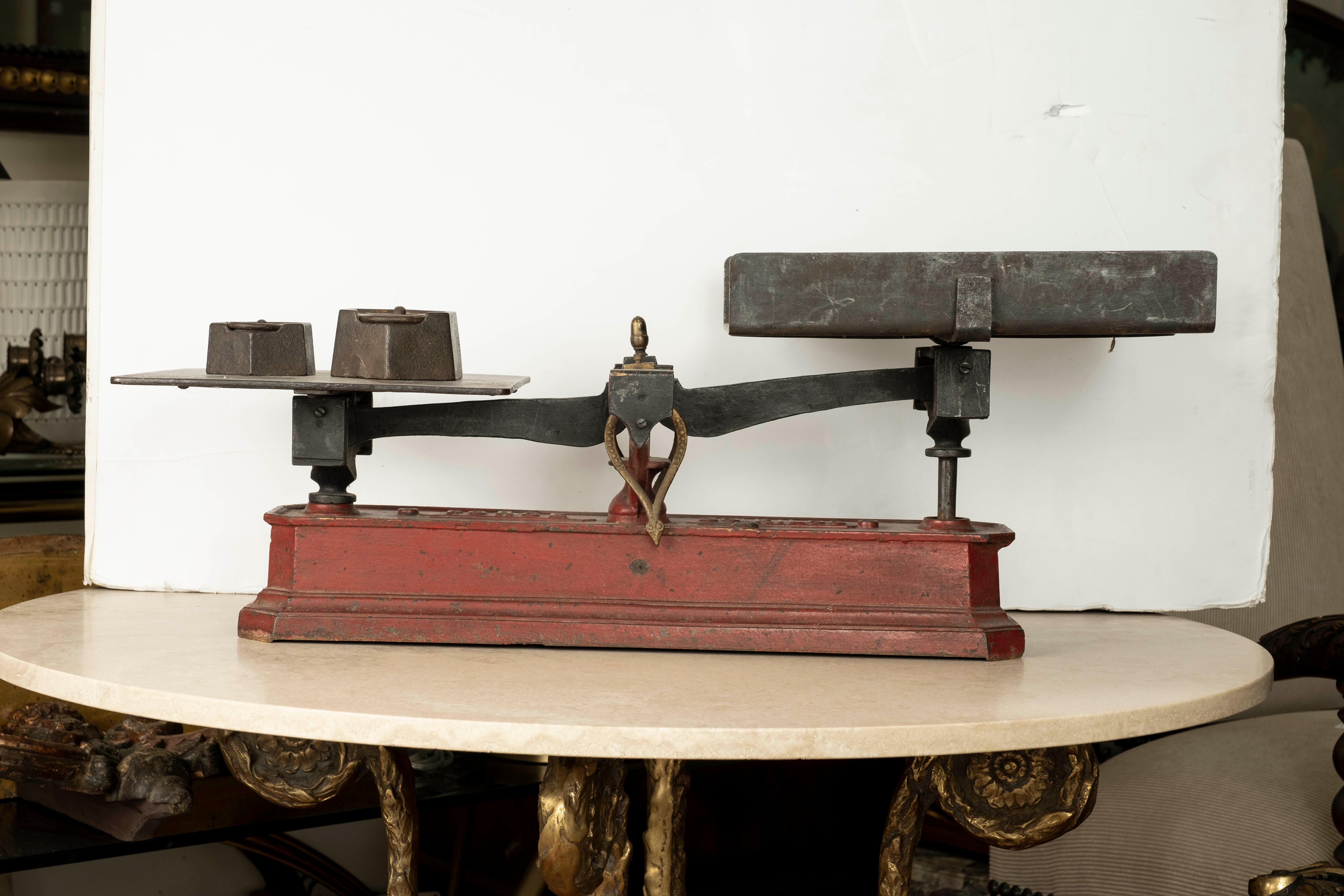 French Baker's scale. This antique cast iron baker's scale includes original weights. 
Great Kitchen Accessory!