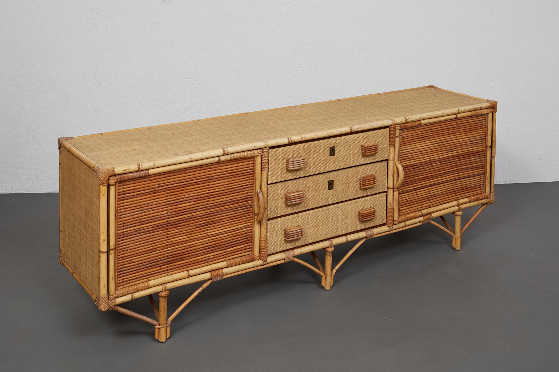 Beautiful bamboo and wrapped rattan sideboard in the style of Adrien Audoux and Frida Minet from France, 1960's. 

This truly original sideboard boasts two doors with interior shelves and three drawers with handles. 

The original finish of the