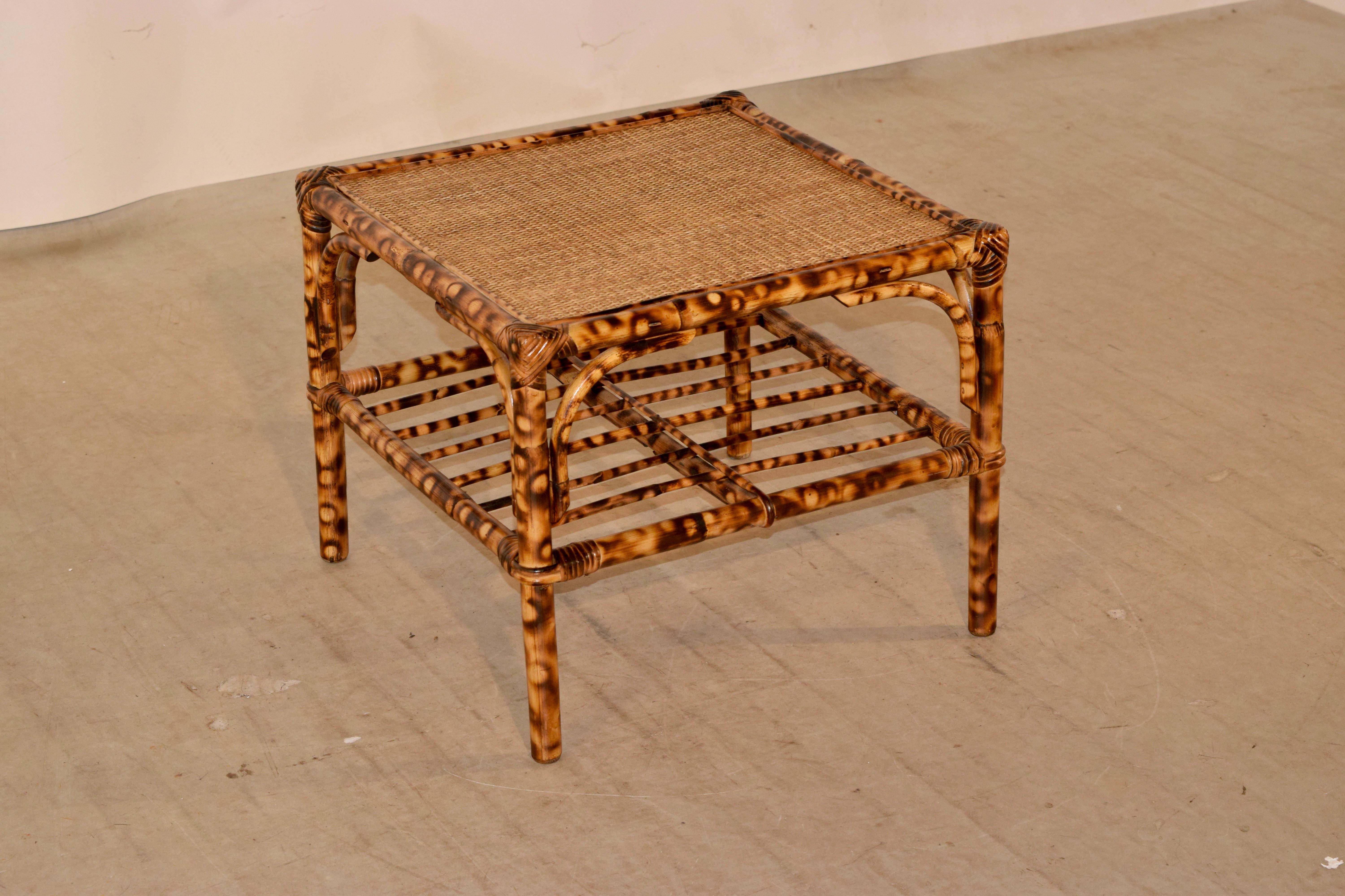 Tortoise bamboo coffee table from France with a woven rush top and slatted lower shelf. Great size and coloring.