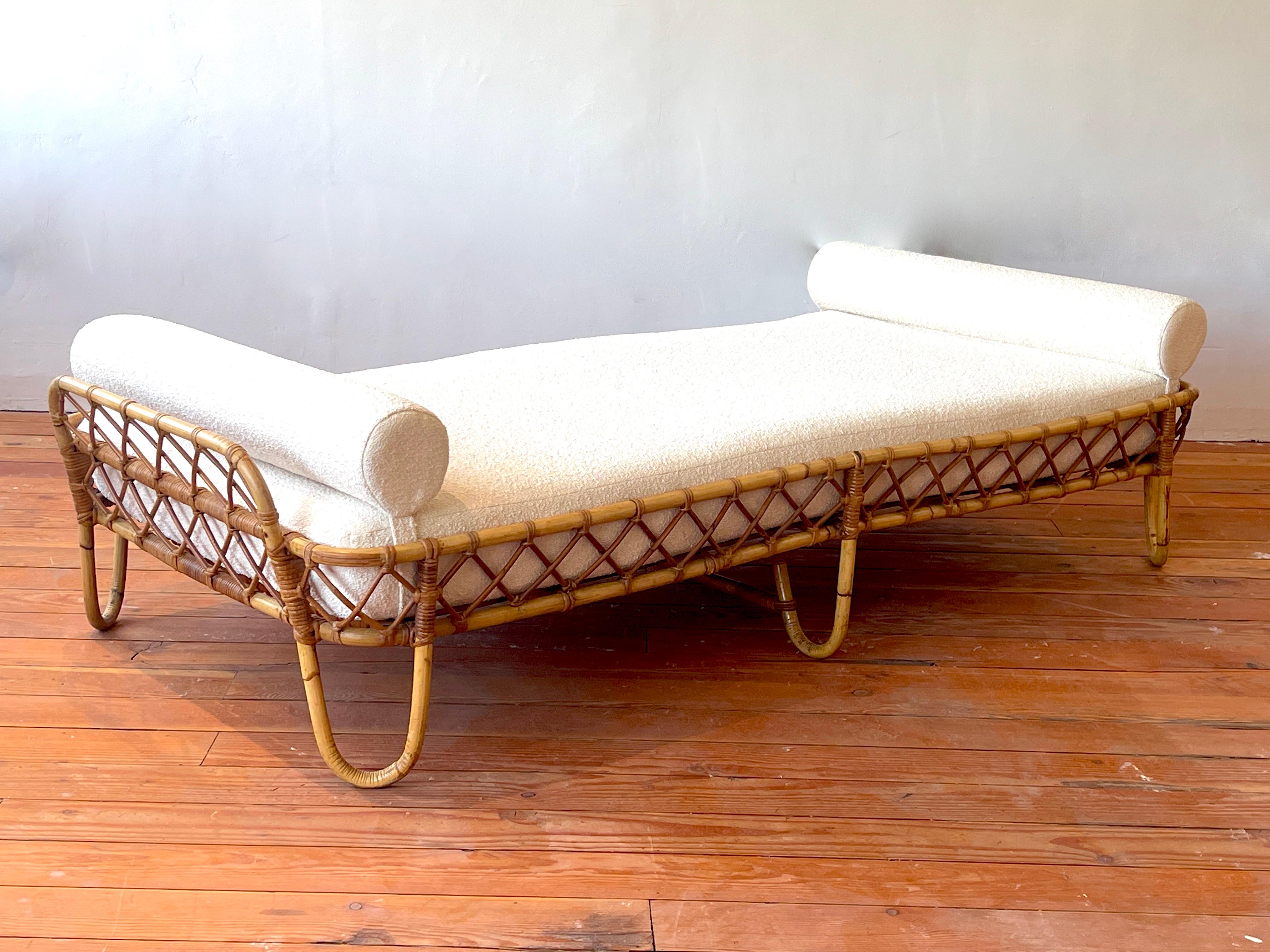 French bamboo daybed, France, circa 1950's.
Newly upholstered in France in creamy white boucle with bolsters on both ends.
Elegant design with hairpin legs and curved headboard.
 