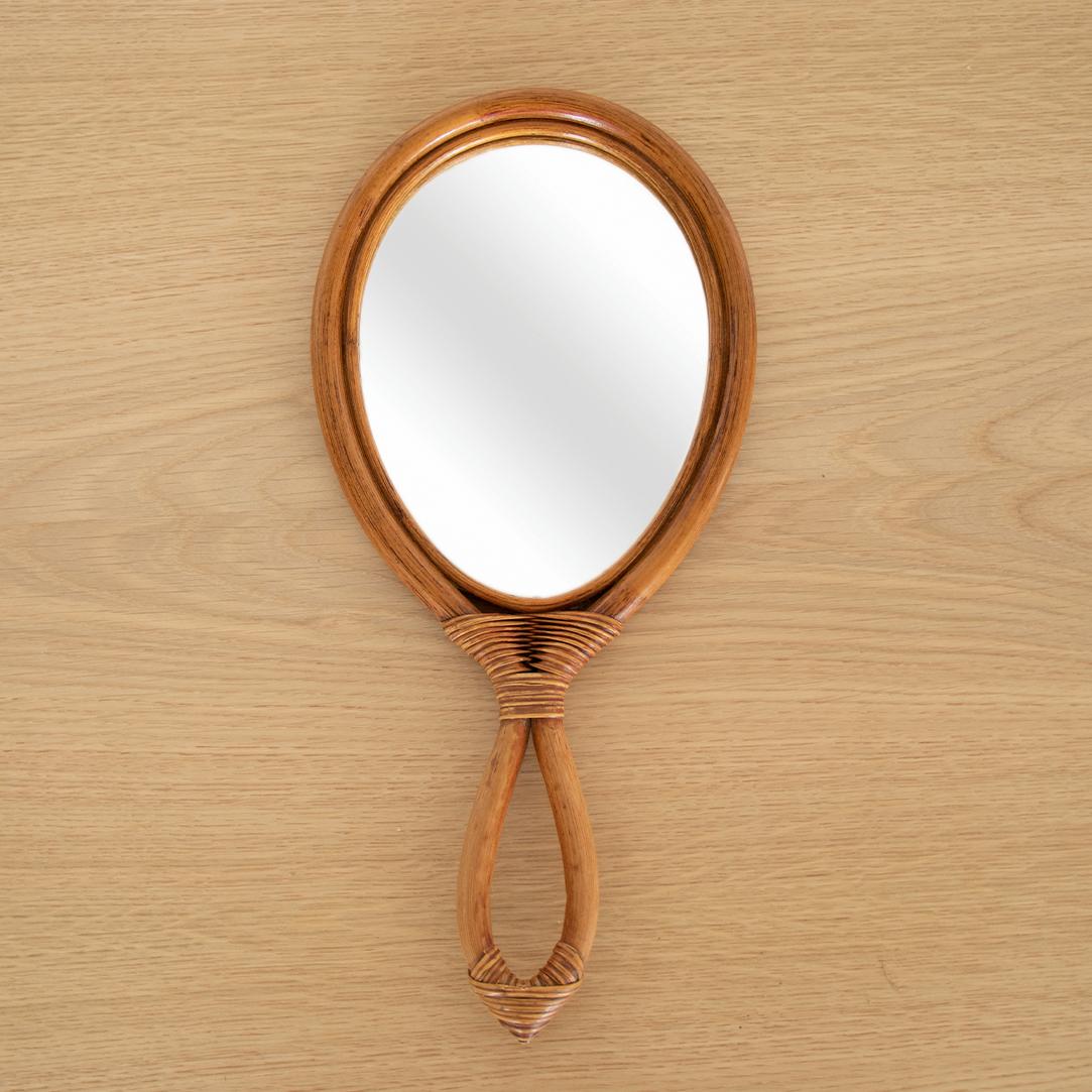 Great vintage bamboo hand-held vanity mirror from France. Teardrop shape bamboo frame with handle and original glass mirror.