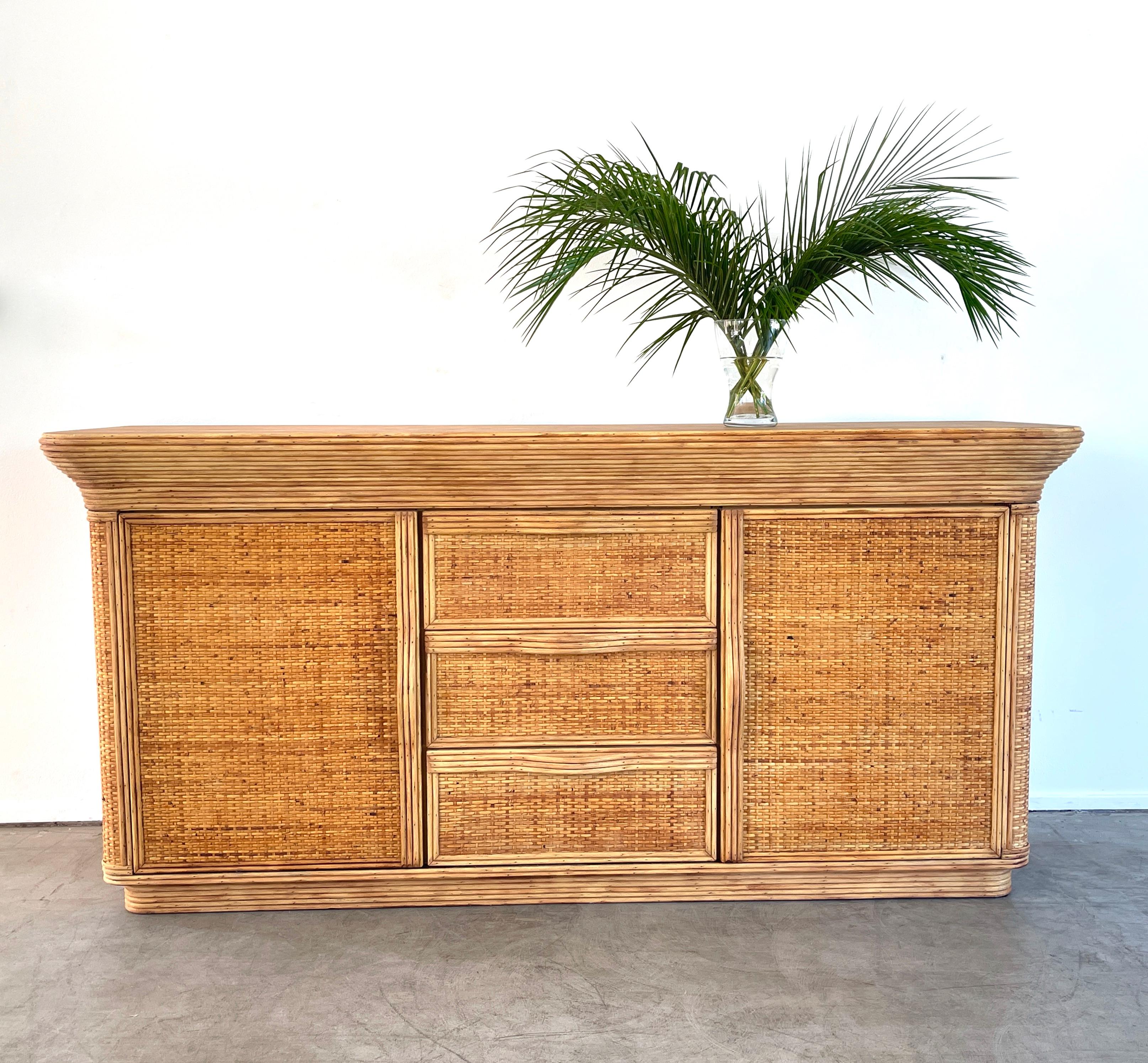 French bamboo sideboard with woven panels, bamboo top and gracefully curved bamboo handles. 
Curved top edge adds sophistication to design 
Great piece!