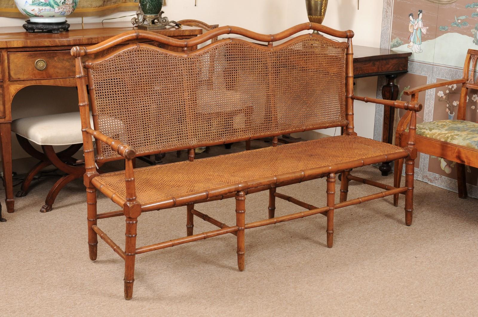 A bamboo style bench with caned back and seat. The bench dating from the late 19th century and French in origin. 

 