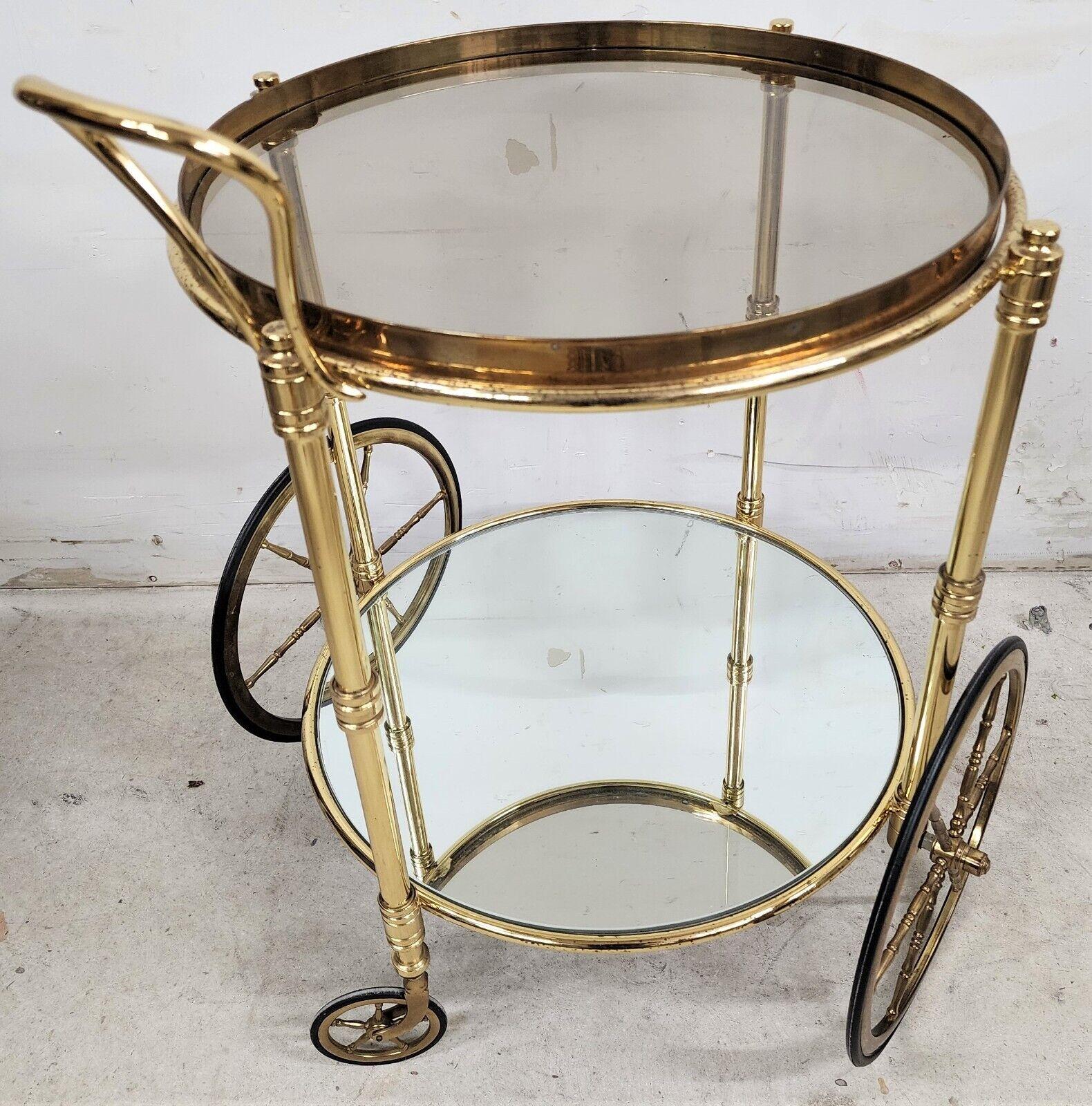 Vintage brass rolling French bar serving trolley cart
Featuring a mirror bottom shelf and a removable glass serving tray on the top level.

Approximate measurements in inches:
24