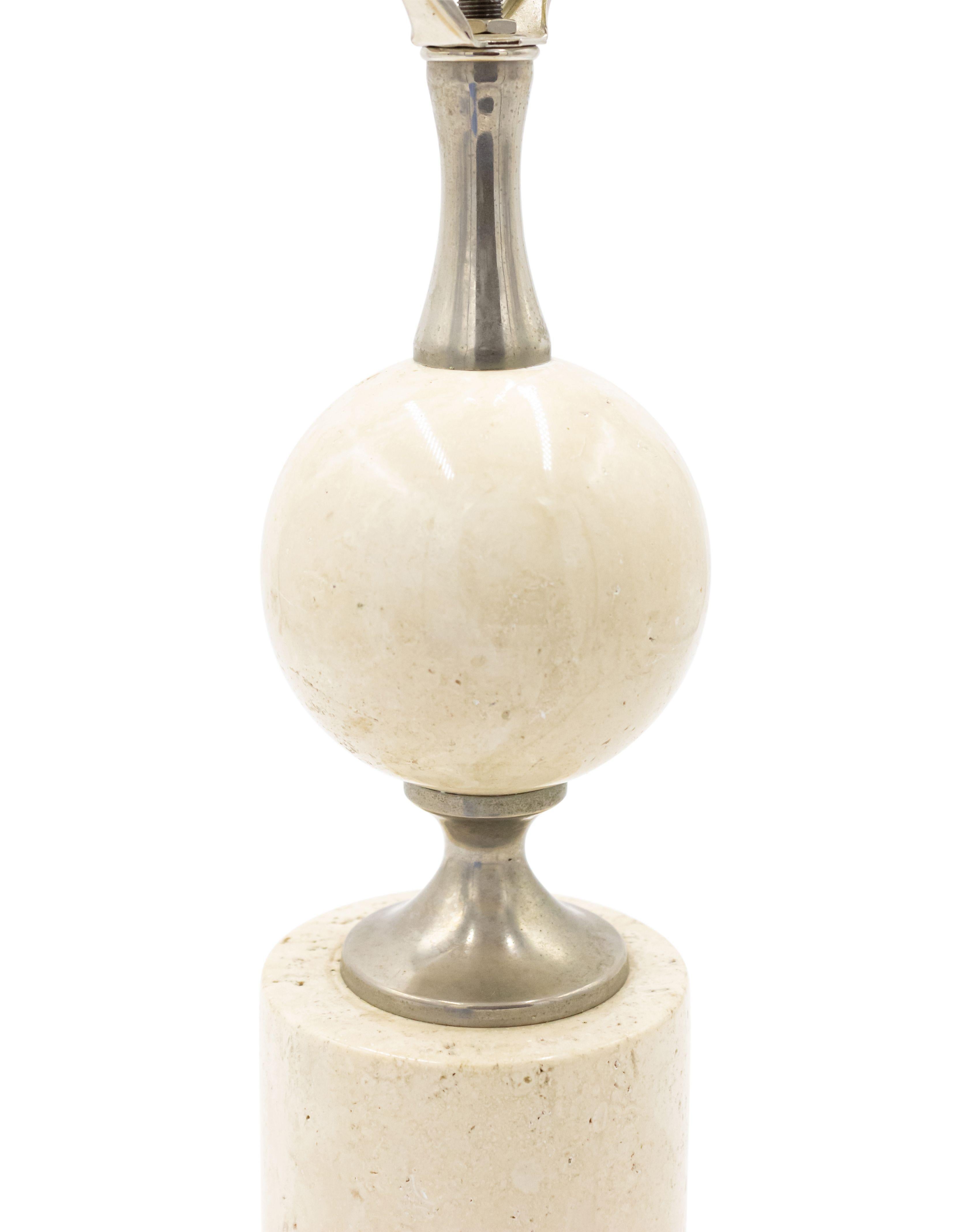 French 1970s table lamp with a travertine cube shaped base separated from a disc shaped travertine element with a chrome connector. (MAISON BARBIER)
