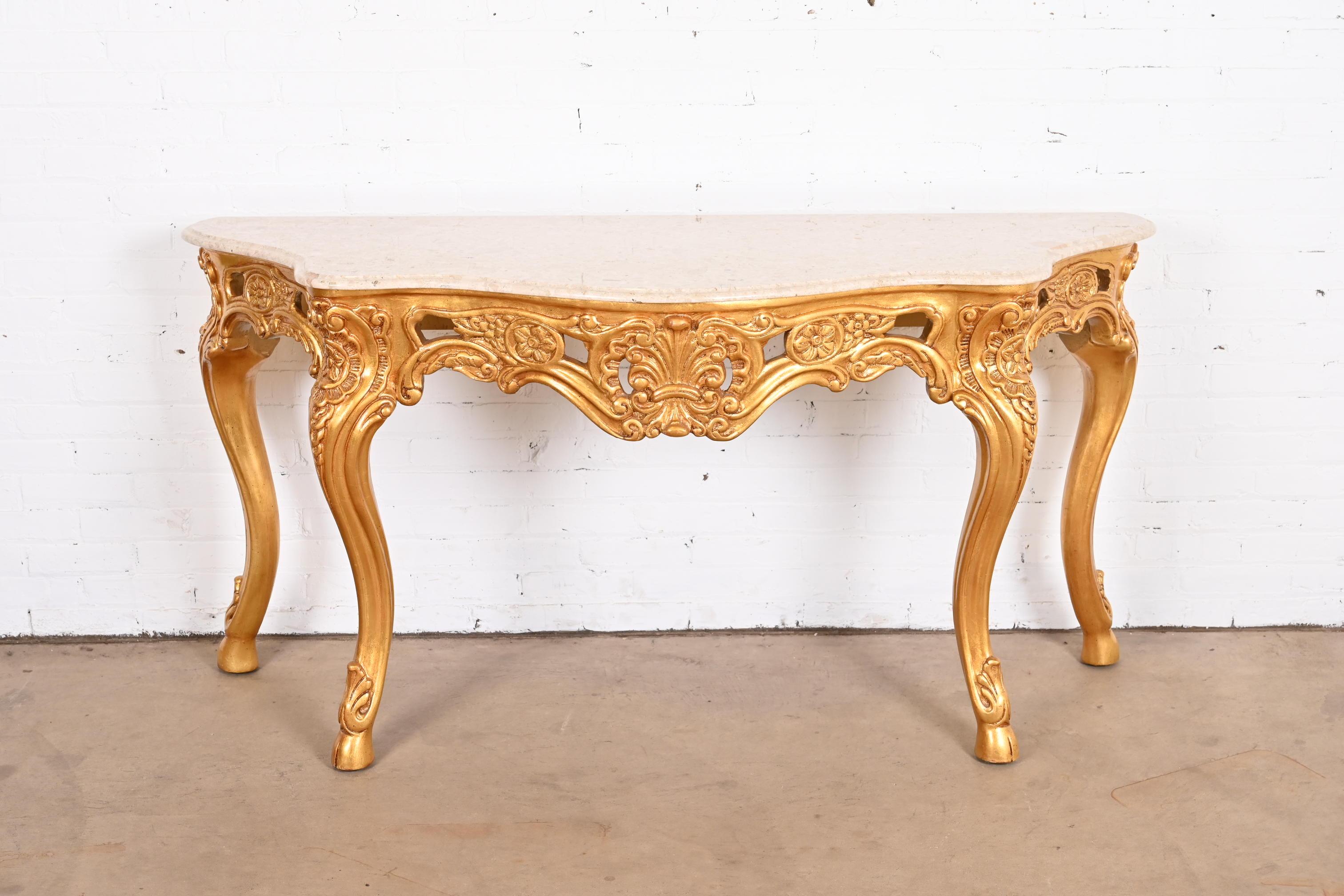 A gorgeous French Baroque or Rococo style console or entry table

Late 20th Century

Carved giltwood, with tan marble top.

Measures: 67.25