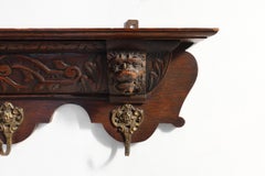 French Baroque coat rack of carved oak with copper hooks