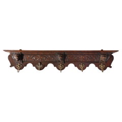French Baroque coat rack of carved oak with copper hooks