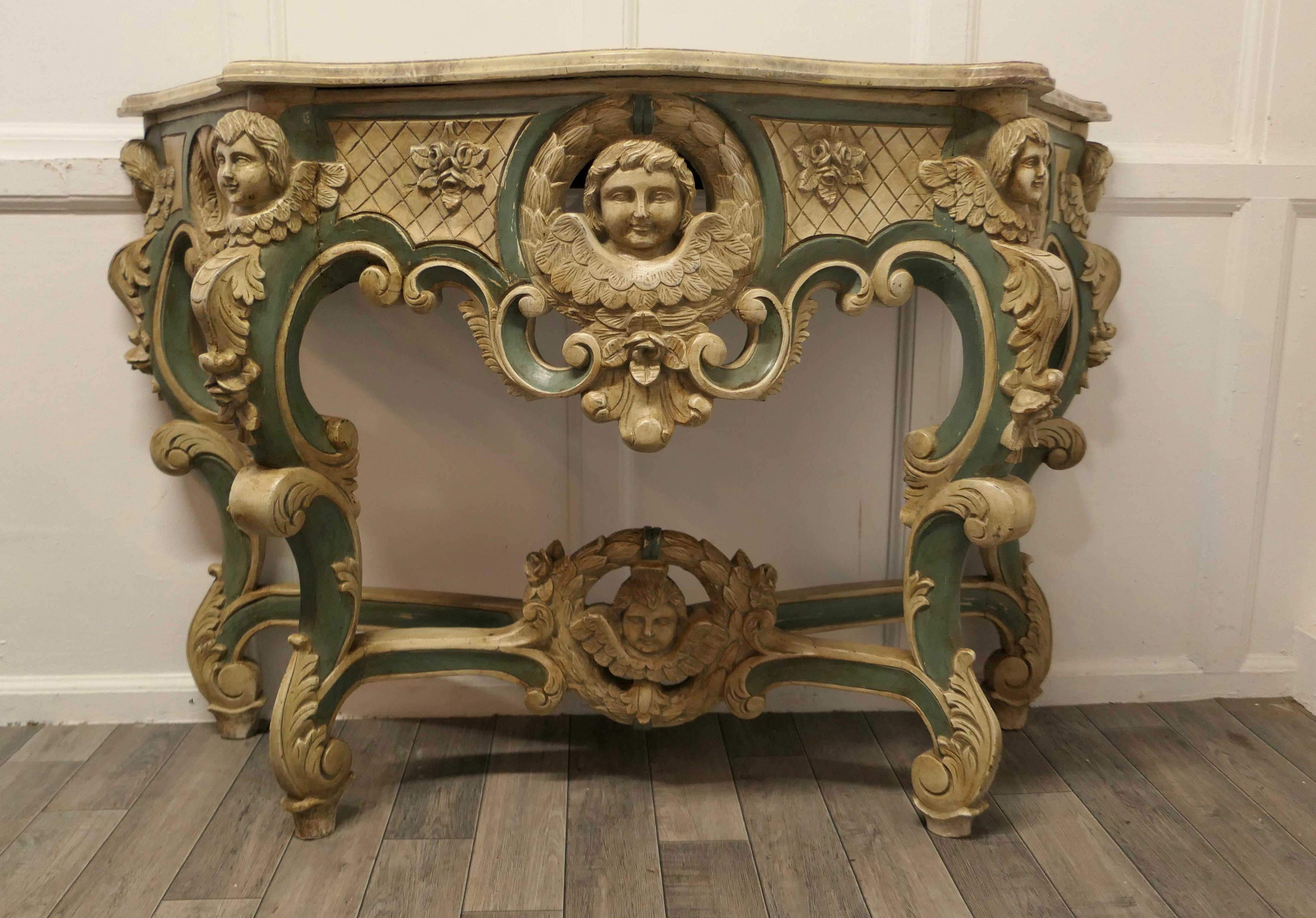 Baroque  Table console baroque française, sculptée et peinte représentant les visages d'anges en vente