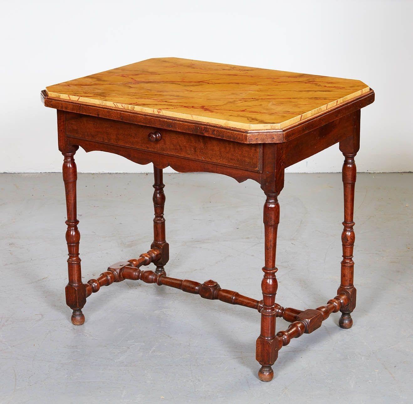 Good late 17th Century French walnut table with octagonal faux marble inset top over single drawer, the turned legs joined by turned 