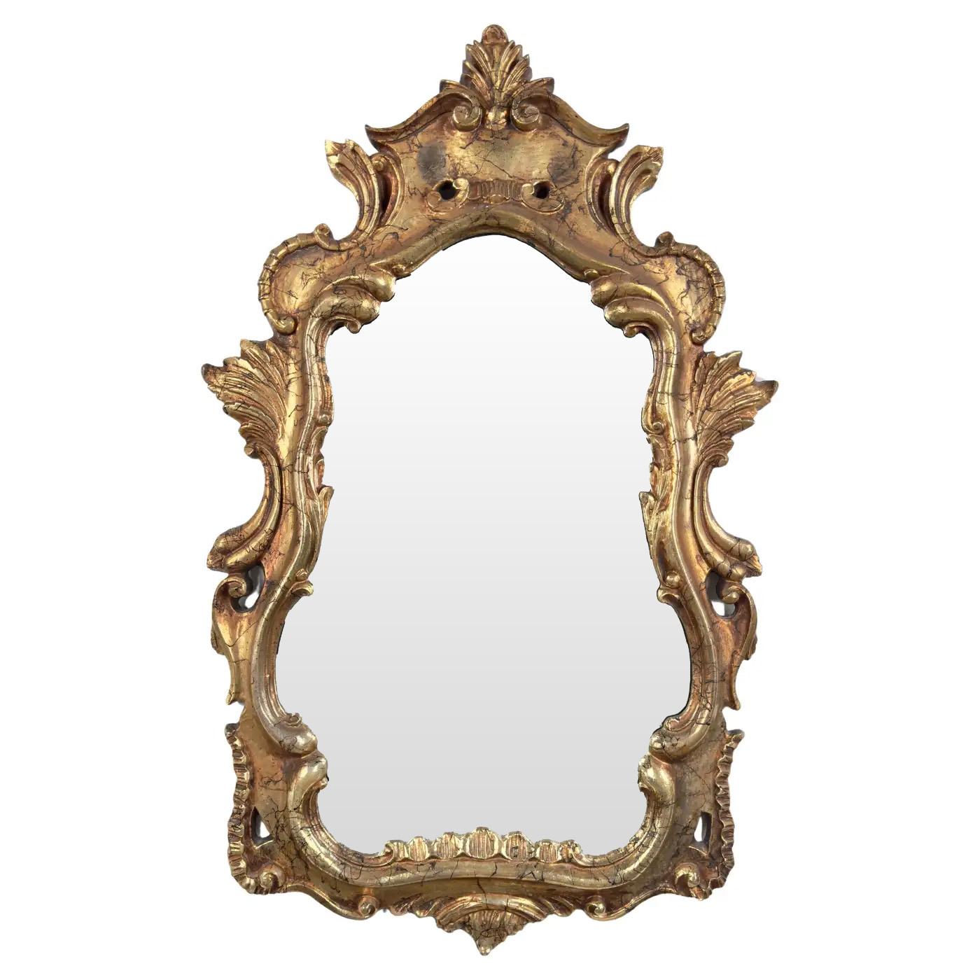 a distinguished pair of French Baroque Louis XV style mirrors. Each mirror showcases a scalloped design, crowned with a majestic acanthus at the top, exuding an air of regal sophistication. The frames are adorned with exquisite leaf details and