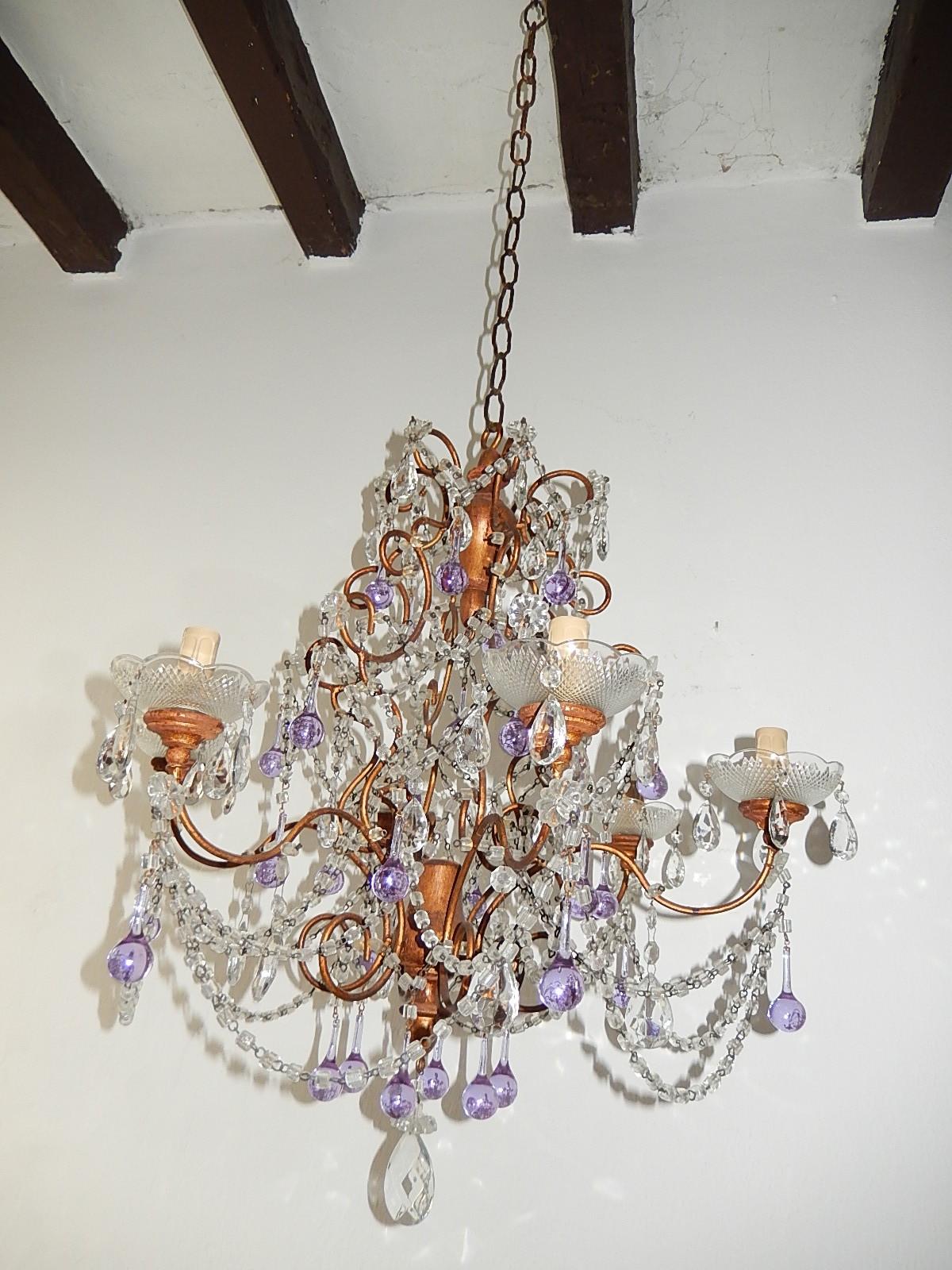 Rewired and ready to hang. Housing six-light, sitting in crystal bobeches, dripping with crystal prisms. Giltwood on top, centre and bottom with florets and macaroni beading swags. Also adorning rare purple Murano drops. Adding another 12 inches of