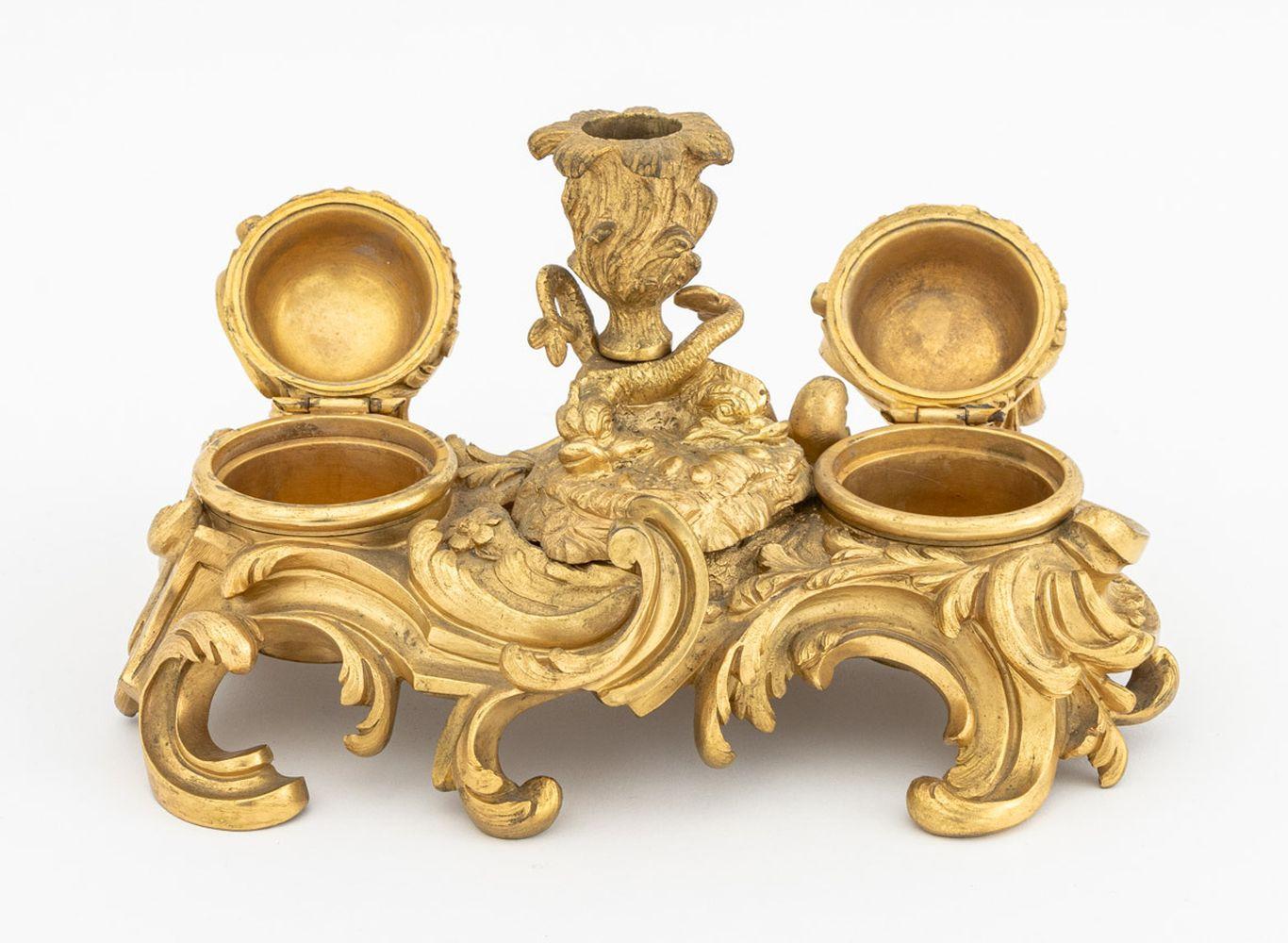 French Baroque Style Gilt Bronze Dore Desk Stand, with two covered acanthus leave inkwells flanking central candlestick holder with porpoise motif and acanthus leaf form base. 4.5