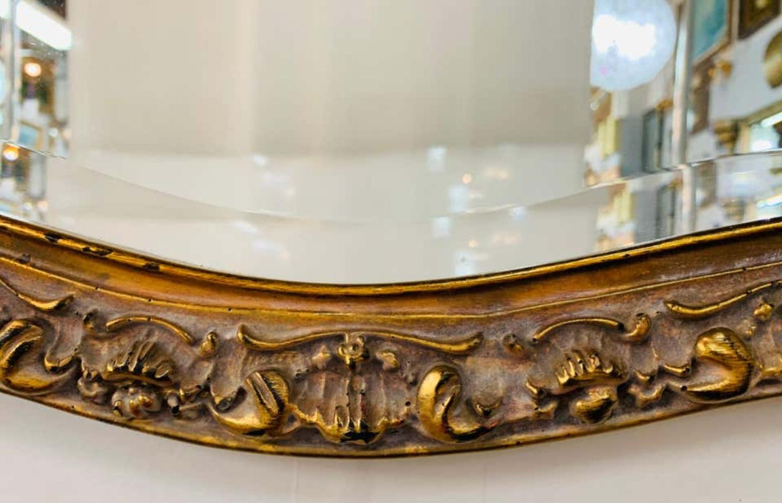 A beautiful French Baroque style mirror made of quality resin. The mirror is finely carved with amazing details and features a charming bow / ribbon with flowers and a beveled edge glass mirror. This mirror displays horizontally and can be placed in