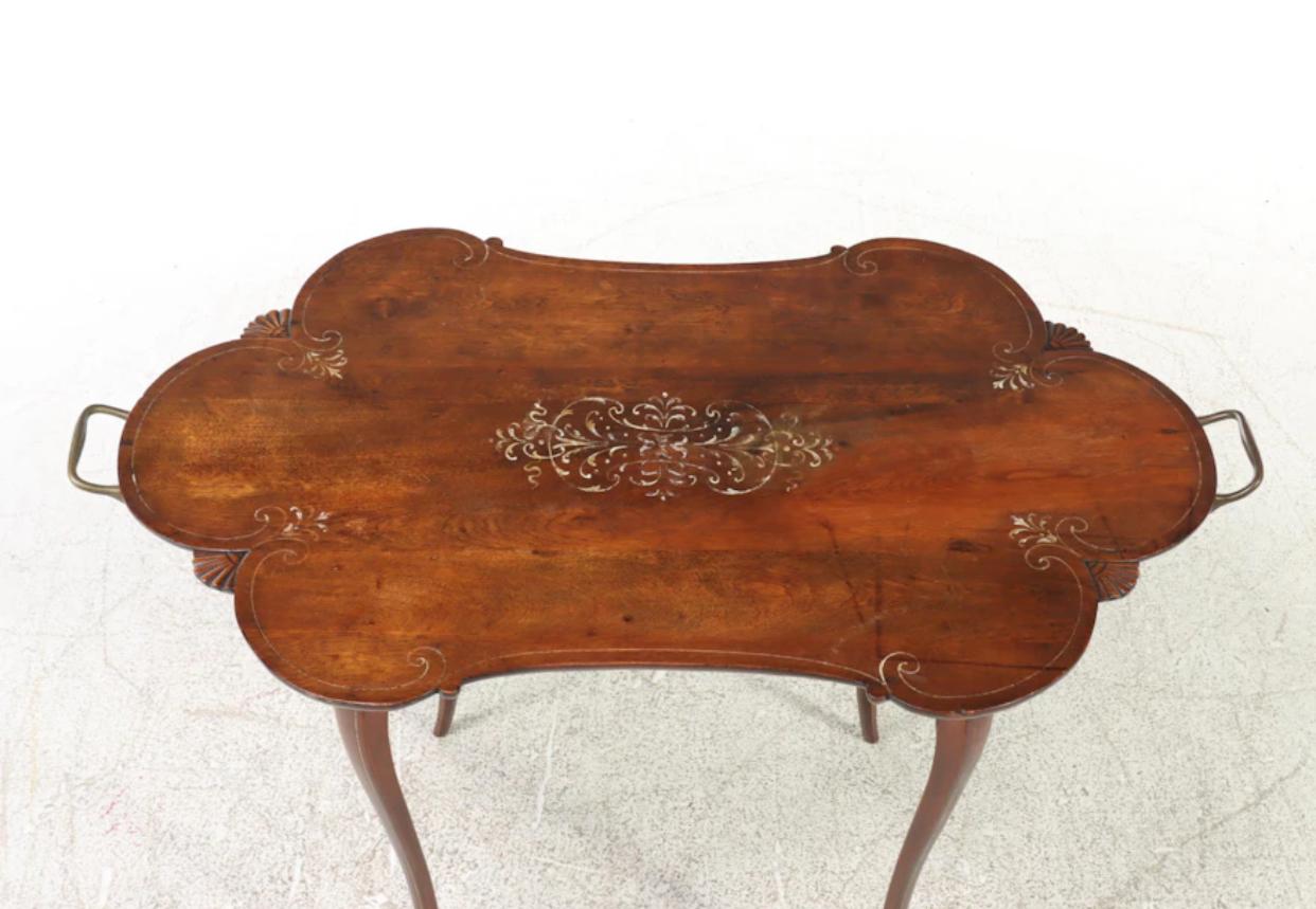 Wonderfully sleek serpentine French Baroque style side table. The legs draw the eye immediately. Slender and, to use the word again, “sleek” cabriole legs. The carved and polychrome detailed top is perfectly aged and it shows. Excellent color of the