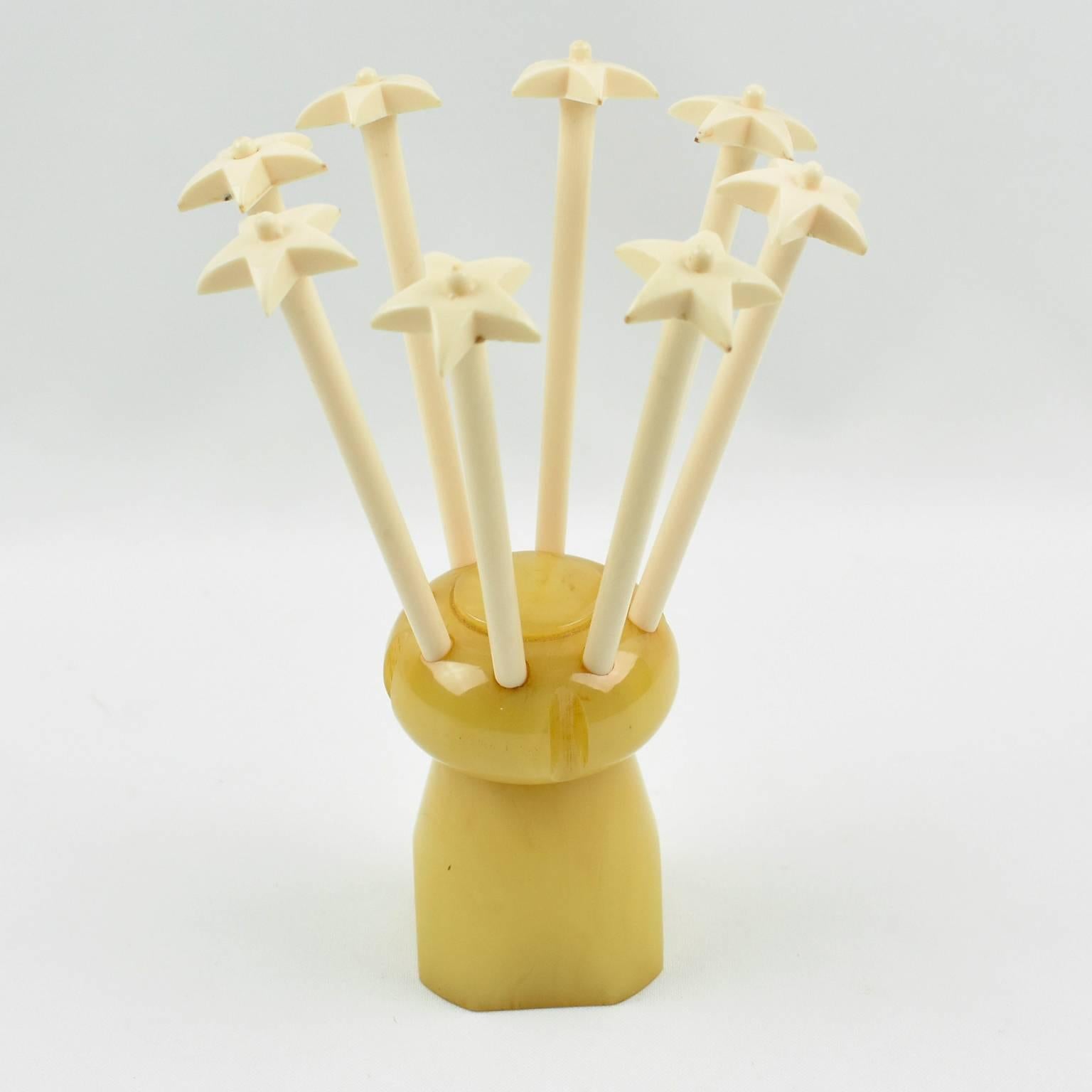 Rare French barware bar set cocktail stirrers. This French Art Deco bar set is build with lemon yellow marble bakelite featuring a huge champagne cork holder with eight long off-white plastic stir sticks with star finial. This set is very stylish -