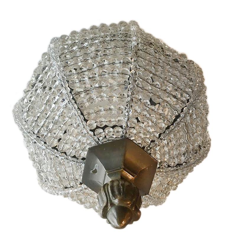 A French circa 1930s neoclassic-style beaded crystal flush-mount light fixture with interior light.

Measurements:
Height of body 12