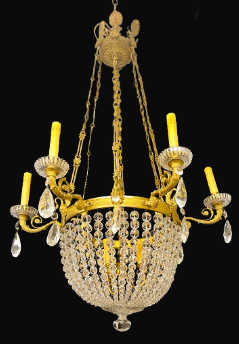 French beaded dome 9 light chandelier having six lights outside and three on the interior of the dome. This finely cast bronze chandelier has crystal bobeches and hangs on decorative bronze chains with a central column support. The bottom having a