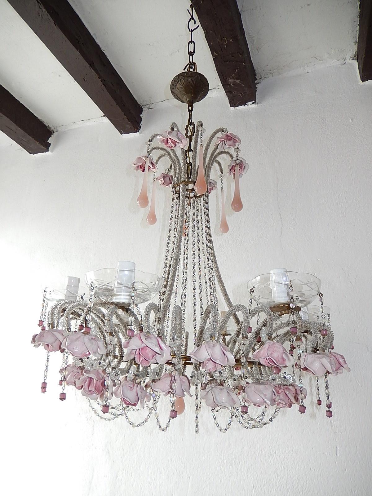 Housing six-light, will be rewired and ready to hang with correct sockets for country. Crystal bobèche dripping with crystal prisms and rare pink opaline encaged beads. Micro beaded throughout. Swags of iridescent beads. Adorning pink handmade