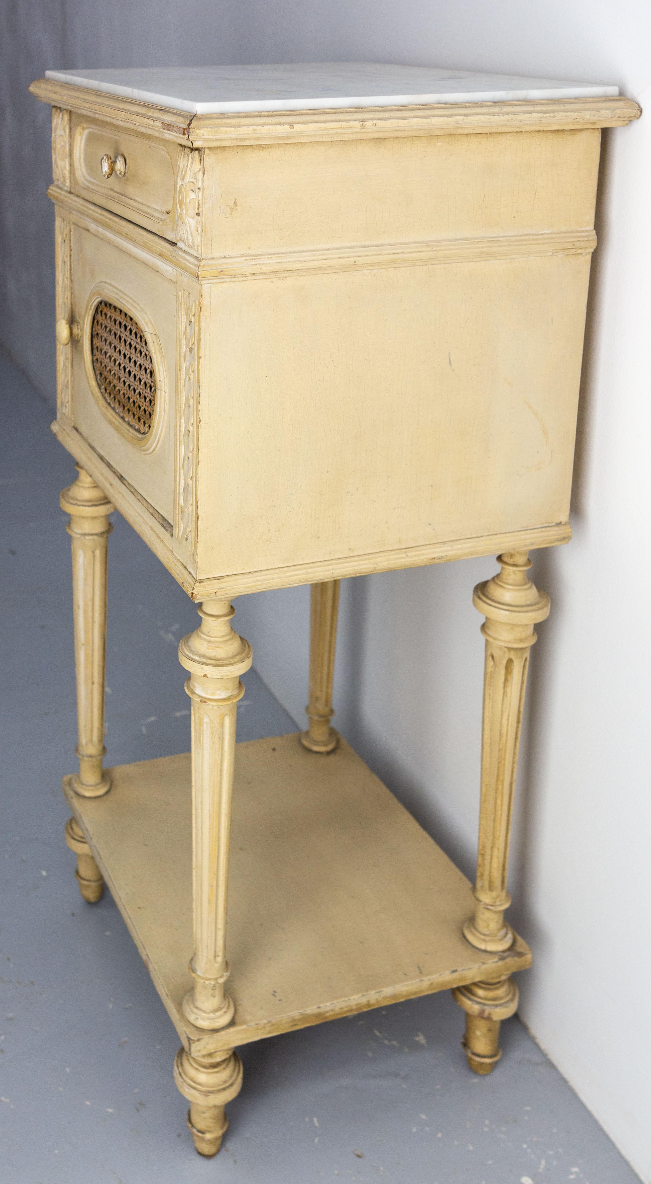 Early 20th Century French Bedside Table Patinated Wood, Marble Top & Cane Door Louis XVI St, c 1900 For Sale