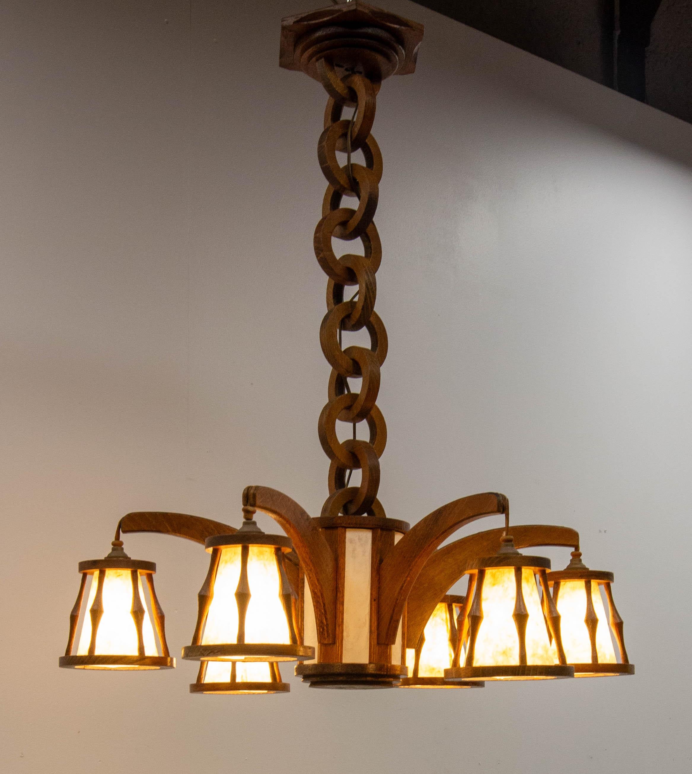 French chandelier or lustre made of beech and with lampshade in parchment paper. 
The lamp shades and the paper central part were recently replaced in a artisanal paper. When the light is on the irregularities of the paper become more visible,