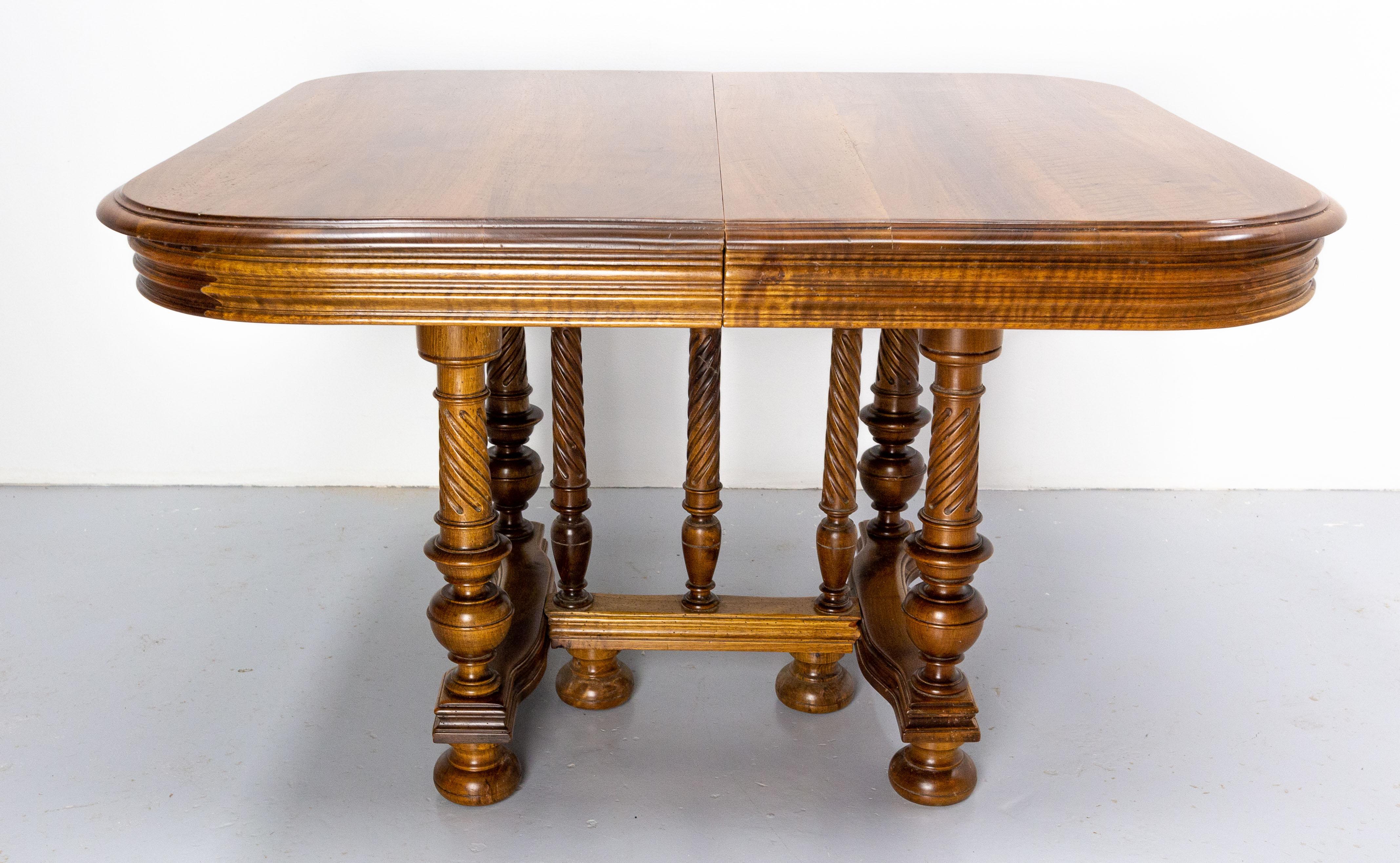 This walnut dining table in the Louis XIII style was made in France.
Without the extensions this table is 44.49 in. (113 cm) long. 
The seven twisted legs are typical of the Louis XIII style.
The extensions of the table are the originals.
Good