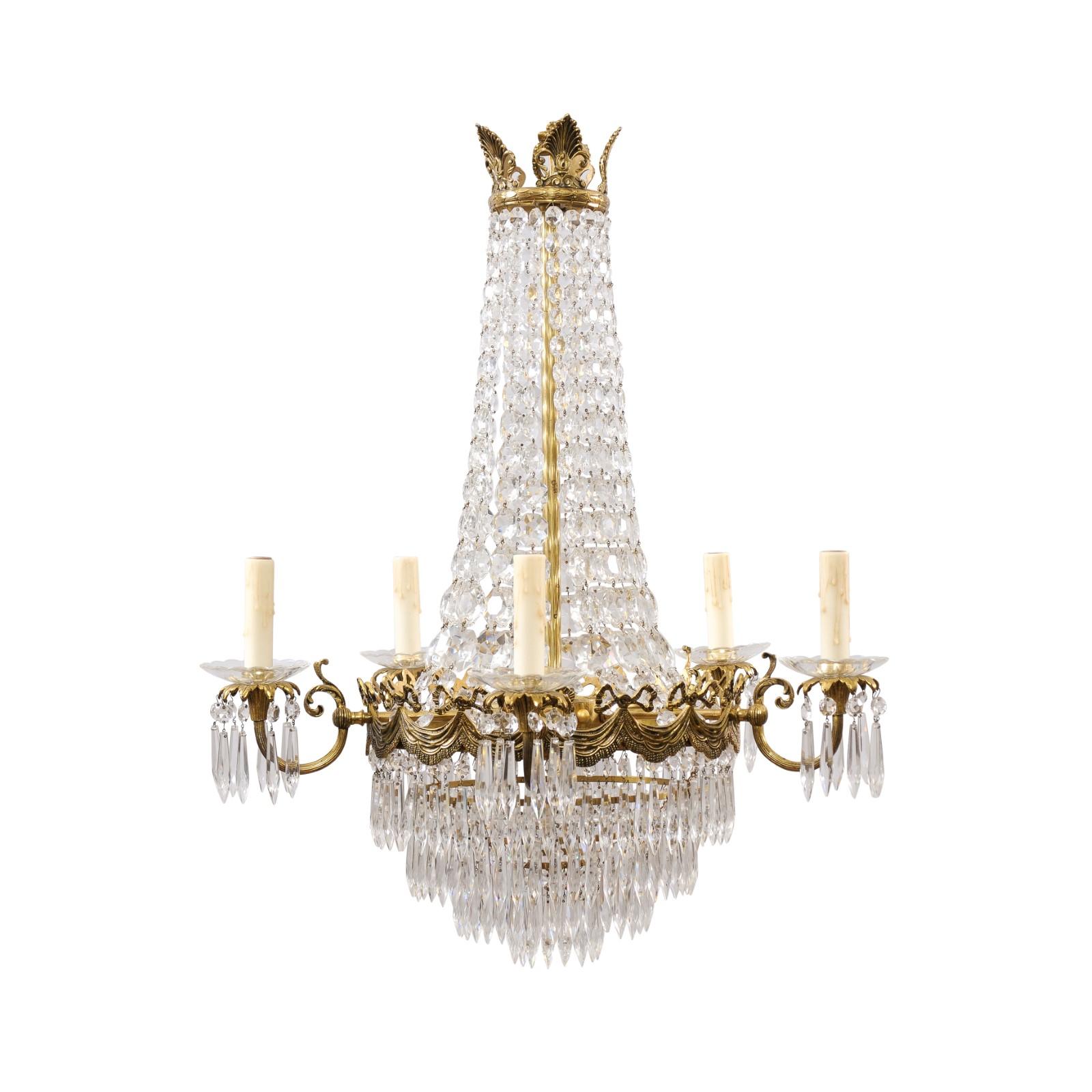 A French Belle Époque crystal and bronze five-light basket chandelier from circa 1890 with palmette and swag motifs. This captivating French Belle Époque chandelier, dating back to circa 1890, is a masterpiece of crystal and bronze, elegantly